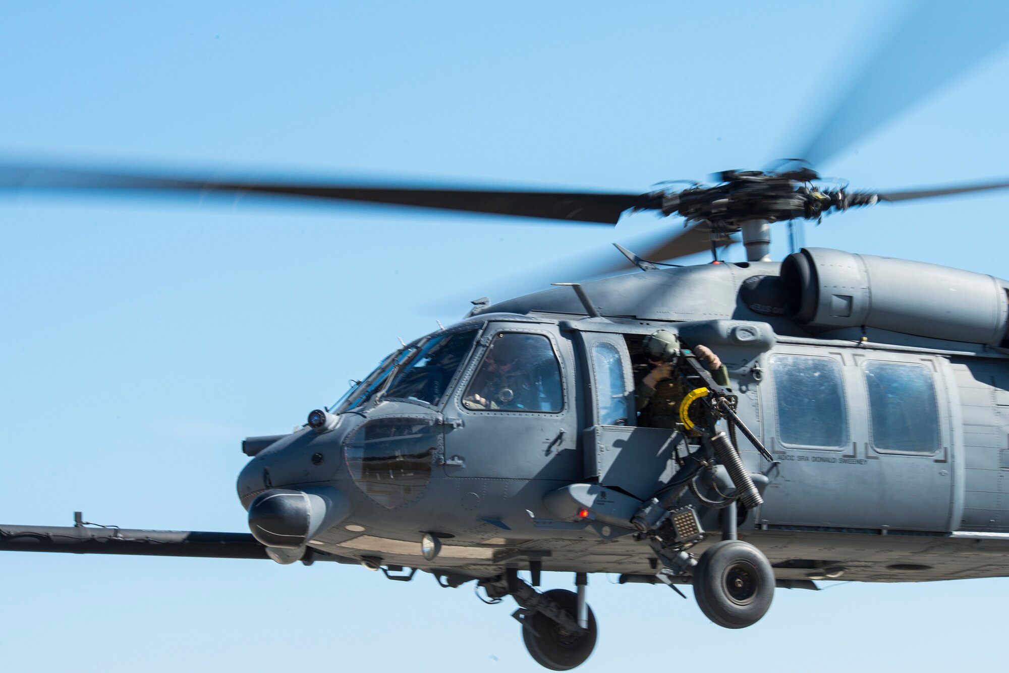 A 41st Rescue Squadron special missions aviator mans a machine gun during a combat search and rescue demonstration at the 2014 Flying Tiger Reunion Heritage Day Nov. 14, 2014, at Moody Air Force Base, Ga. The special missions aviator scanned the area for enemies after rescuing a survivor from enemy territory.  (U.S. Air Force photo by Airman 1st Class Ceaira Tinsley/Released)
