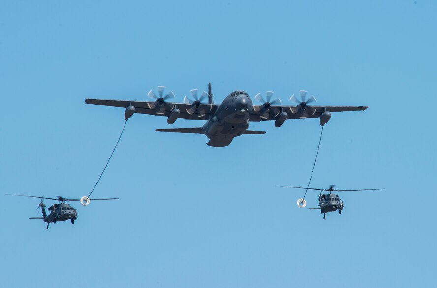 An HC-130J Combat King II and two HH-60G Pave Hawks fly over the crowd during the 2014 Flying Tiger Reunion Heritage Day Nov. 14, 2014 at Moody Air Force Base, Ga. The HC-130J provided fuel for the helicopters prior to the start of the combat search and rescue demonstration. (U.S. Air Force photo by Airman 1st Class Ceaira Tinsley/Released)