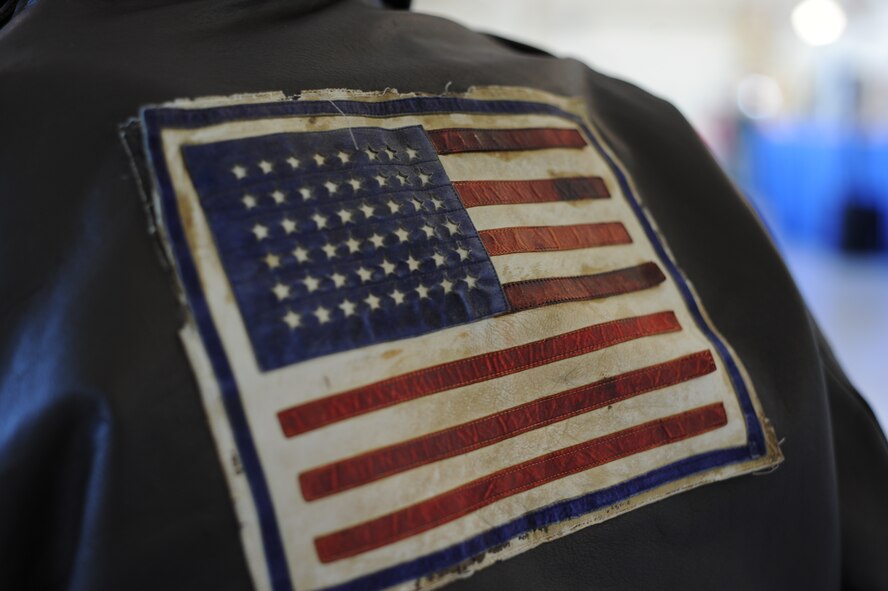 Don Miller, a former 75th Fighter Squadron pilot and World War II veteran, wears his tattered leather bomber jacket during the 2014 Flying Tigers Reunion Nov. 14, 2014, at Moody Air Force Base, Ga. Miller proudly wears his jacket and notes that the U.S. flag only has 48 stars.  (U.S. Air Force photo by Andrea Jenkins/Released)