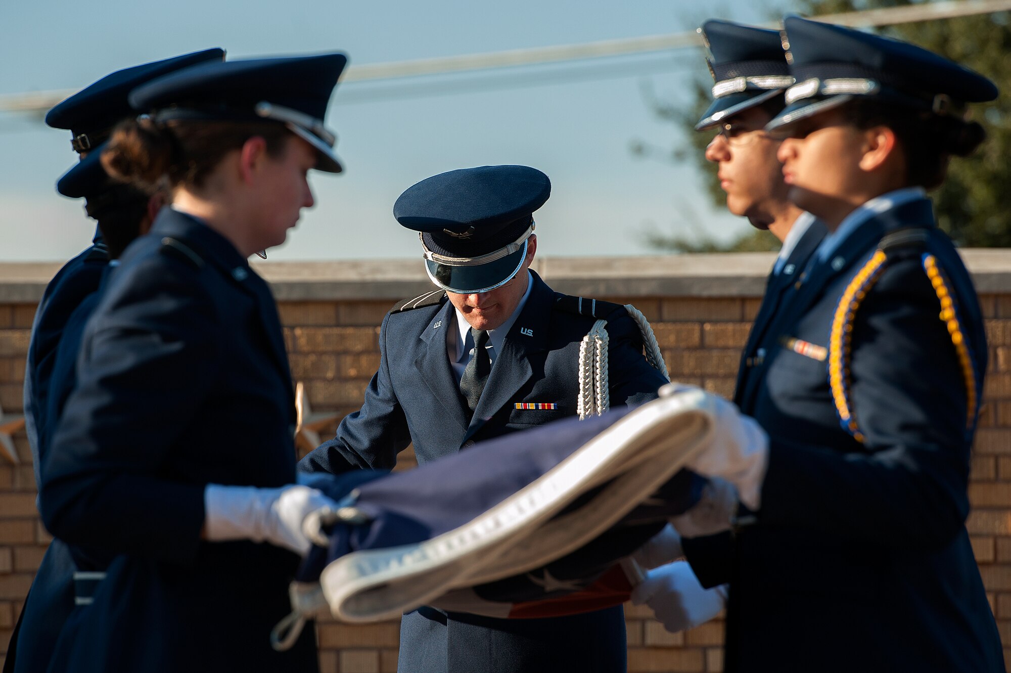 SAN ANGELO, Texas – Andrew Childers, Angelo State University Air Force ROTC cadet, folds the American Flag during the 2014 Air Force ROTC Flag Retreat at ASU Nov. 12. The flag is carefully folded into the shape of a tri-cornered hat, emblematic of the colonial soldiers’ hats during the war for independence. (U.S. Air Force photo/ Airman 1st Class Devin Boyer)