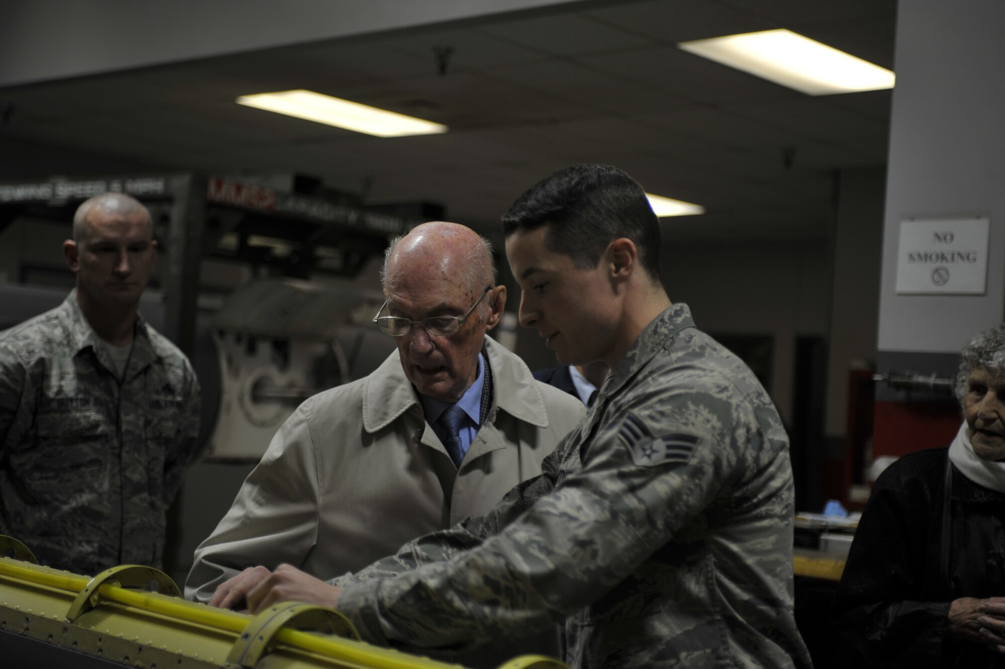 Senior Airman Derrick Gentner, 92nd Maintenance Group aircraft hydraulic systems specialist, shows retired Chief Master Sgt. of the Air Force James McCoy a refueling boom his shop is currently repairing Nov. 12, 2014, on Fairchild Air Force Base, Wash. Gentner explained how this boom is used to perform aerial refueling. (U.S. Air Force photo/Airman 1st Class Taylor Bourgeous) 