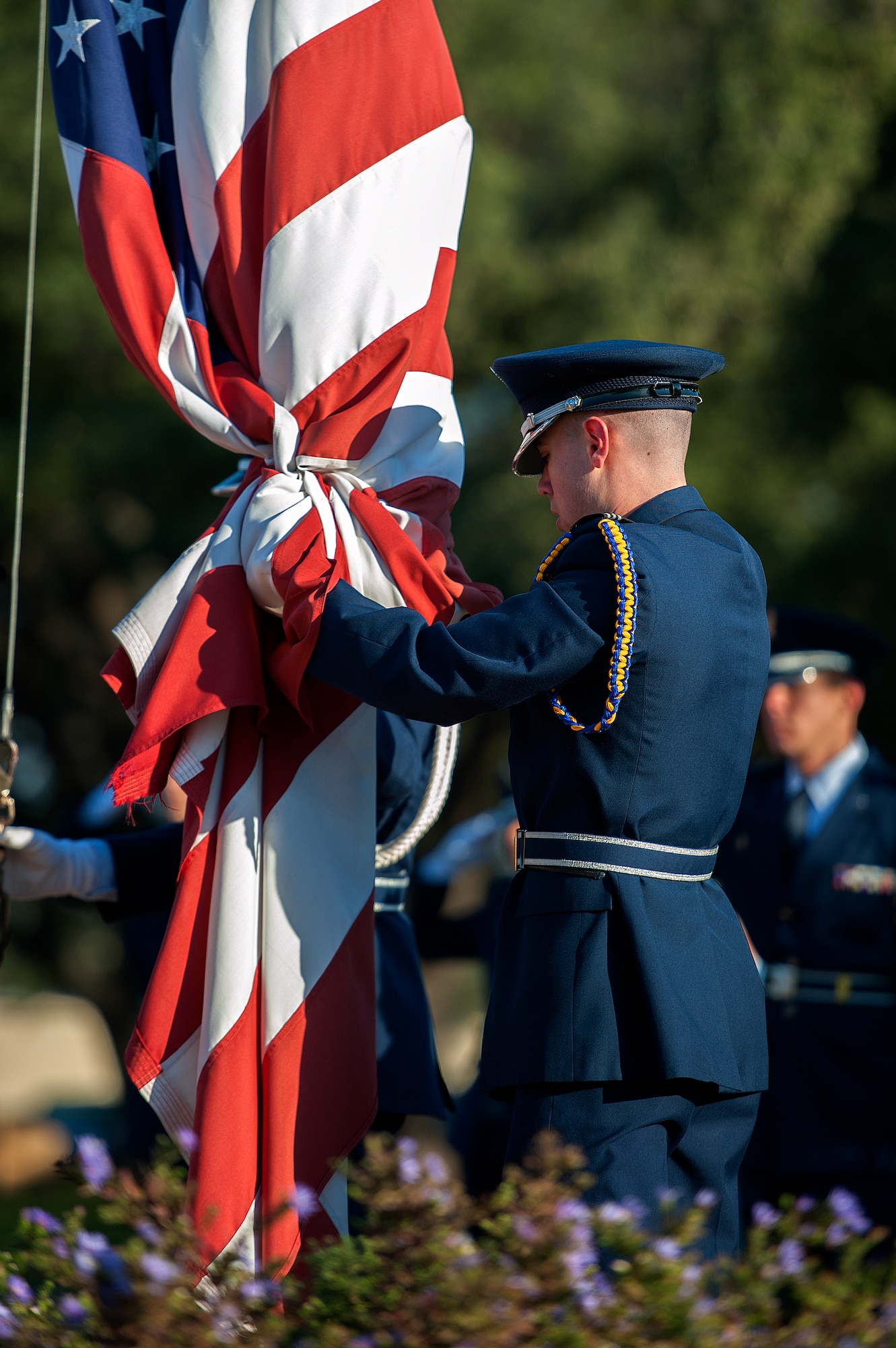 SAN ANGELO, Texas – Joshua Draper, Angelo State University Air Force ROTC cadet, grabs the American Flag as it lowers during the 2014 Air Force ROTC Flag Retreat at ASU Nov. 12. The flag retreat coincided with a candlelight vigil ceremony honoring service members who paid the ultimate sacrifice. (U.S. Air Force photo/ Airman 1st Class Devin Boyer)