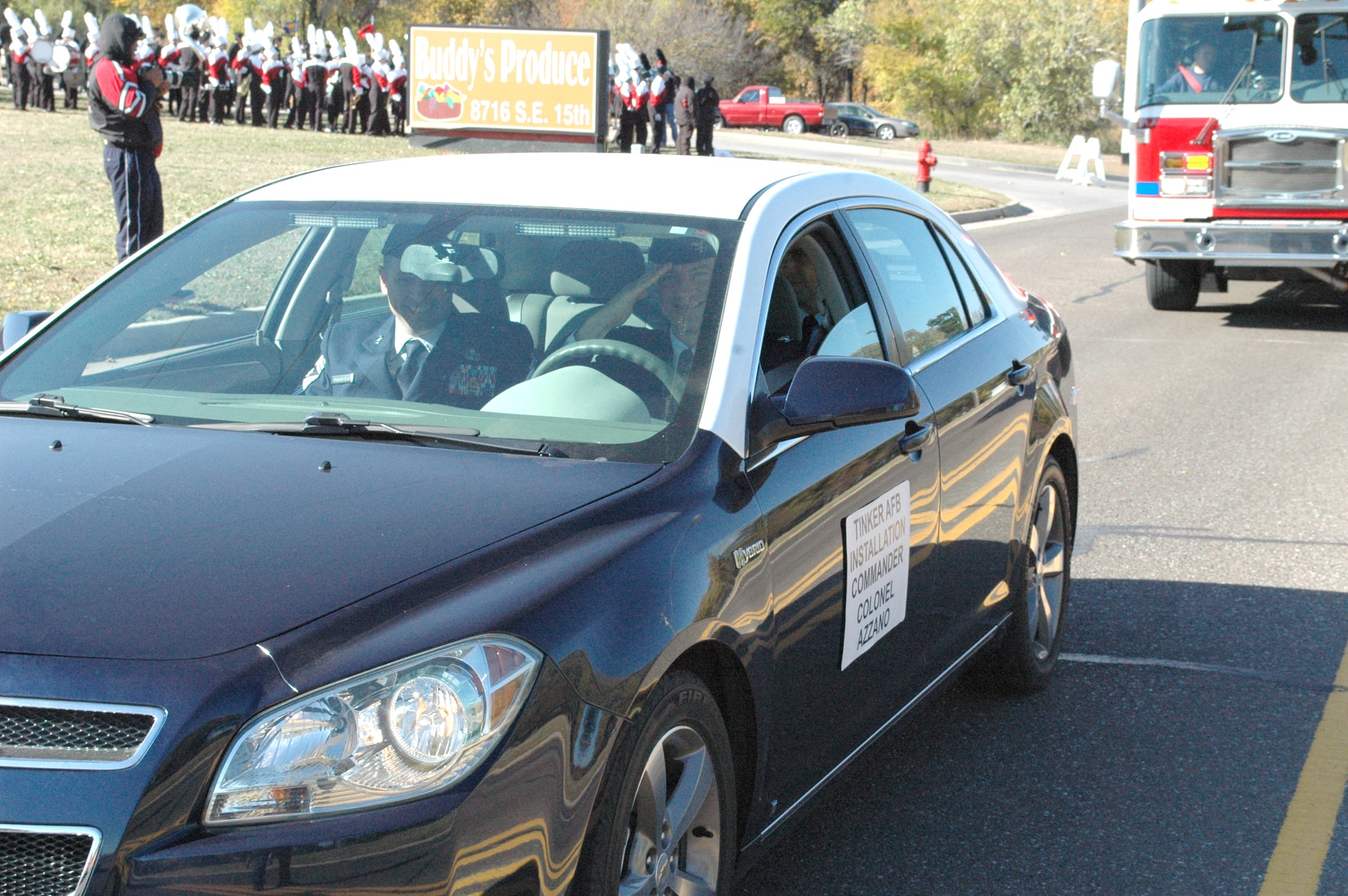 Col. Christopher Azzano, 72nd Air Base Wing and Tinker installation commander, salutes as he begins the Midwest City Veterans Day parade Tuesday. Riding with Colonel Azzano is 72nd ABW Command Chief Master Sgt. Thomas Christopher. (Air Force photo by Jerry Bryza)