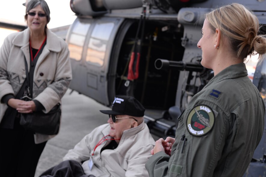 U.S. Air Force Capt. Chandra Fleming, 75th Fighter Squadron A-10C Thunderbolt II pilot, listens as Frank Epperson, former 75th FS pilot and World War II veteran, tells his story during the 2014 Flying Tiger Reunion heritage day, Nov. 14, 2014, at Moody Air Force Base, Ga.  Epperson has attended Flying Tiger reunions since 1946.  (U.S. Air Force photo by Master Sgt. Sonny Cohrs/Released)