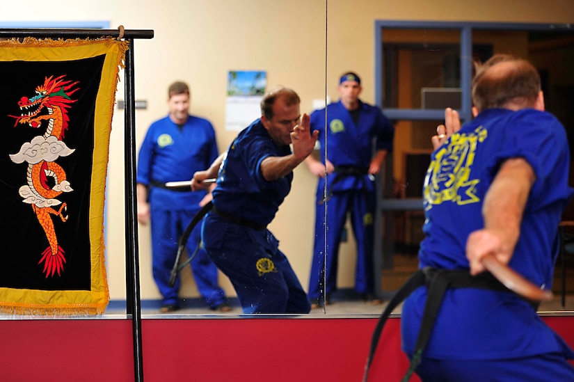 Harold Bromell, Air Combat Command Information Operations program manager, practices kata with a wooden sword at the Community Commons at Langley Air Force Base, Va., Oct. 20, 2014. In Do Hap Sool, there are eight geups, or rankings, and four dans, or degrees of expertise. (U.S. Air Force photo by Airman 1st Class Breonna Veal/Released)