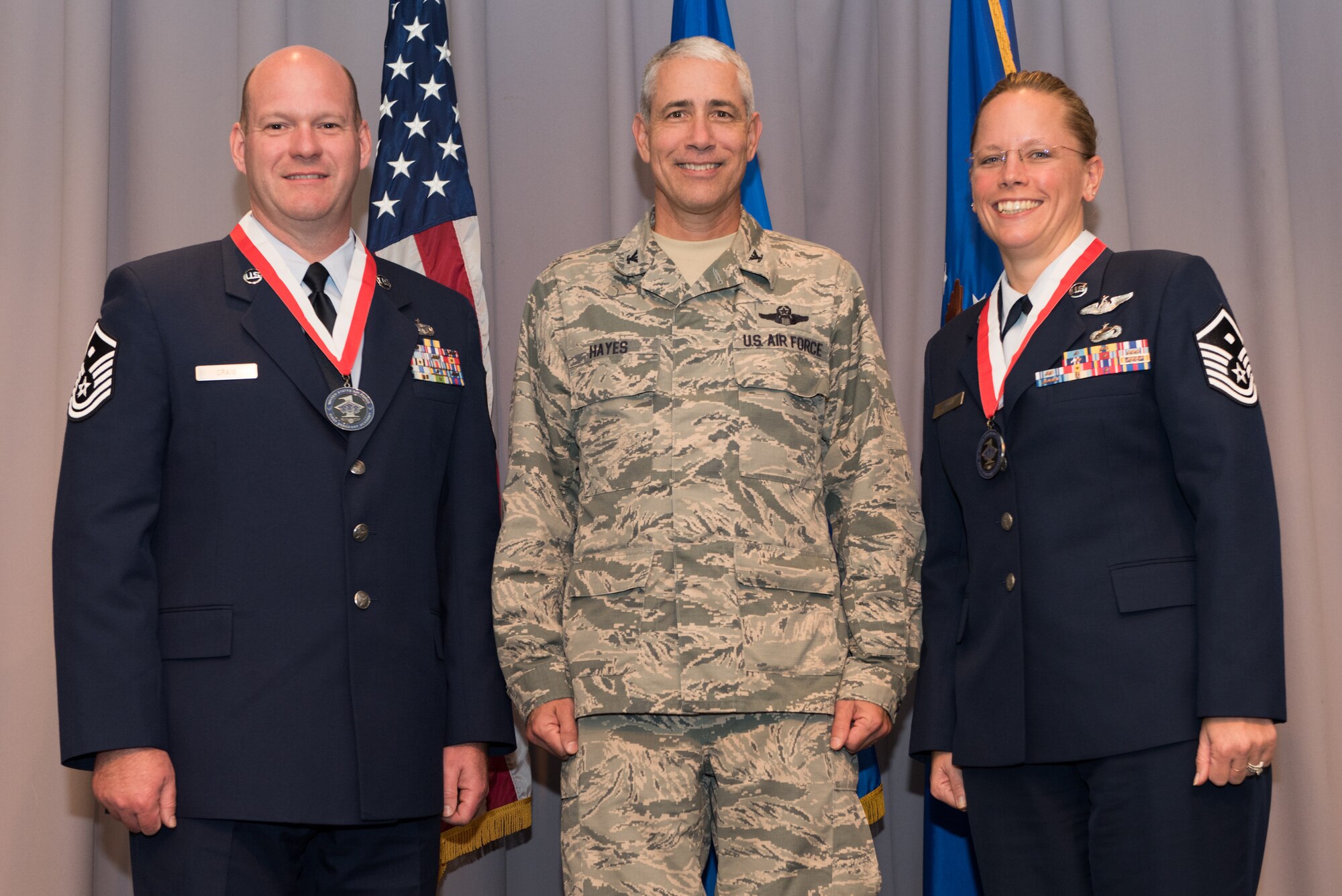 Col. J. Scott Hayes, 512th Airlift Wing vice commander, stands with Master Sgts. Carrie Huot and Christian Craig Nov. 7, 2014, following their graduation from the First Sergeant Academy, Maxwell Air Force Base, Ala. Huot is the 712th Aircraft Maintenance Squadron first sergeant, and Craig is the 512th Aerospace Medicine Squadron first sergeant. (Courtesy photo)