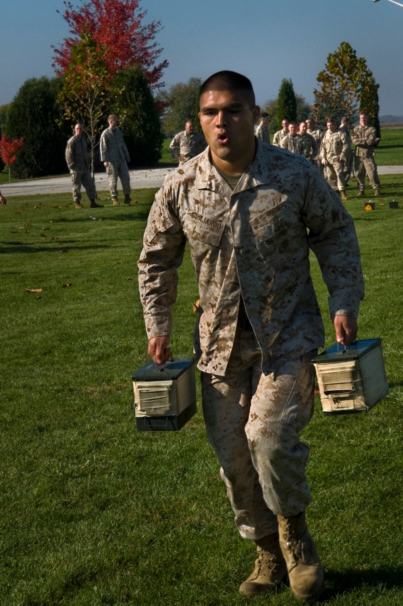 U.S. Marine Corps Cpl. Alonso Guajardo, Detachment 1, Communication Company, Combat Logistics Regiment 45, 4th Marine Logistics Group ground radio repairer, carries ammo cans through an obstacle course during an annual combat fitness test at Grissom Air Reserve Base, Ind., Oct. 25, 2014. CFTs ensure Marines are capable of conducting combat day-to day operations. (U.S. Air Force photo/Senior Airman Jami K. Lancette)