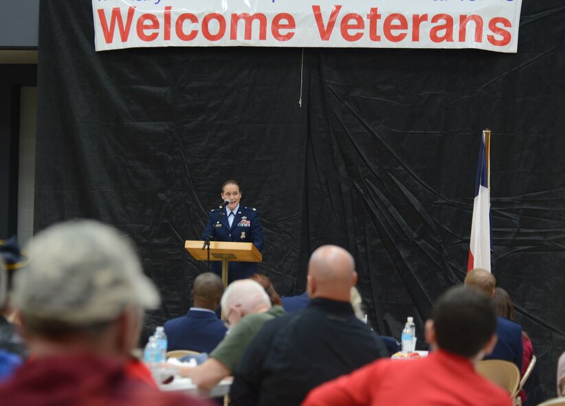 U.S. Air Force Maj. Sarah Babbitt, 7th Security Forces Squadron commander, speaks to veterans during the 2014 Veterans Day Celebration and Benefits Fair Nov. 8, 2014, in Abilene, Texas. Babbitt explained the impact women have had in the military and challenged women to continue striving for success. (U.S. Air Force photo by Senior Airman Peter Thompson/Released)