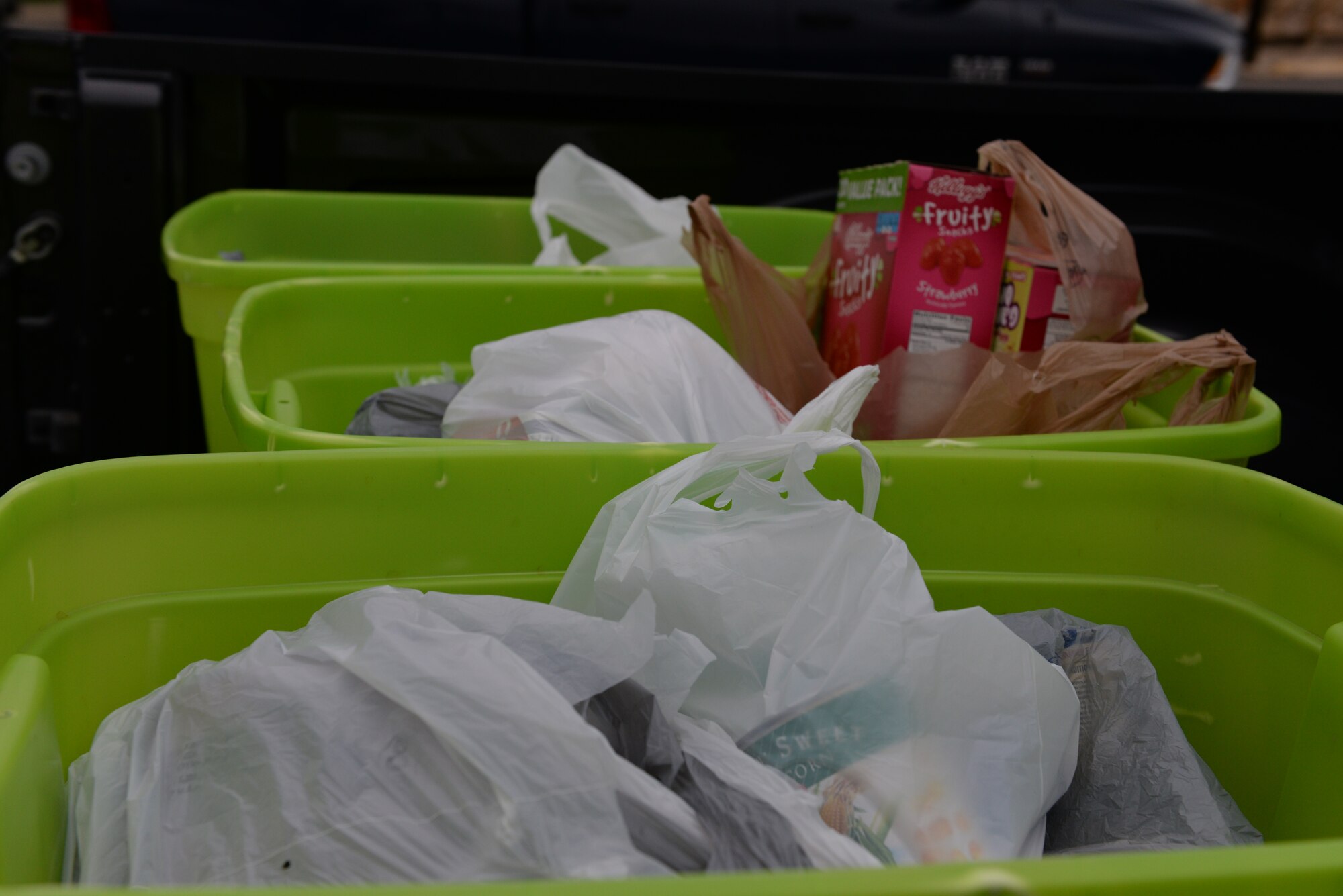 Bags of food are placed in bins during the 4th annual Running with the Bulls 5K and 10K at the Brown Plaza in Del Rio, Texas, Nov. 8, 2014. This year members could bring food to donate at the beginning of the run for a chance to win door prizes. (U.S. Air Force photo by Airman 1st Class Jimmie D. Pike)(Released)