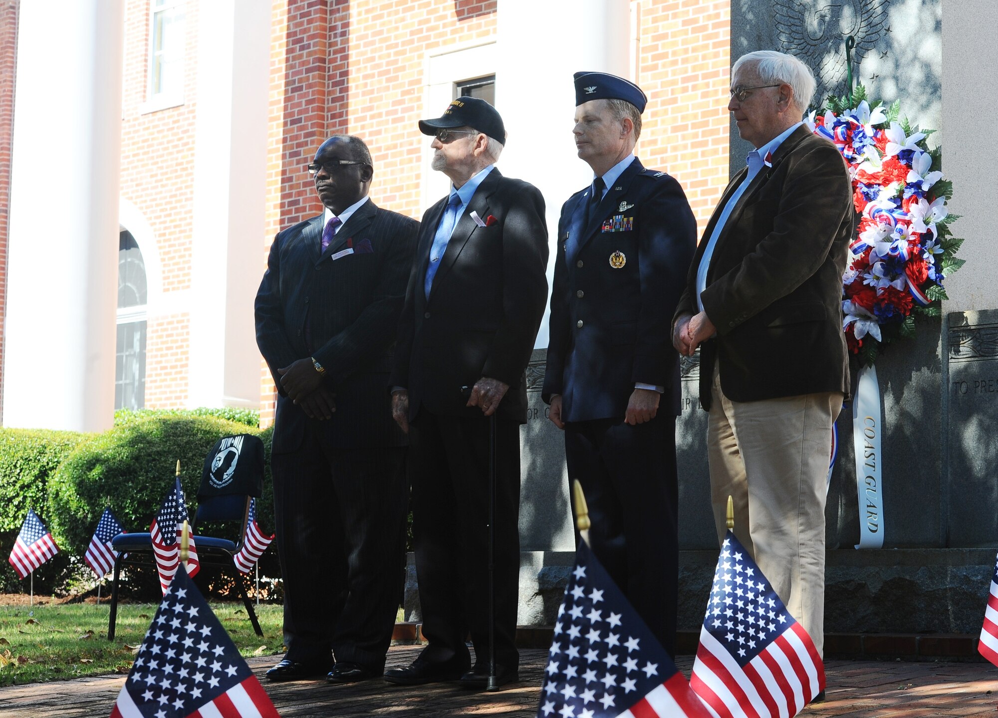 The Honorable Robert Smith, Mayor of Columbus, Harry Sanders, President of the Lowndes County Board of Supervisors, Col. Howard McArthur, 14th Flying Training Wing Vice Commander, and retired Air Force Senior Master Sgt. Elvin Taylor stand by after placing a wreath honoring all members, past and present, of the United States Armed Forces at a Veterans Day ceremony Nov. 8 at the Lowndes County Courthouse. Following the wreath-laying, Emily Waits, wife of a deployed service member, sang “Amazing Grace.” (U.S. Air Force photo/Airman John Day) 