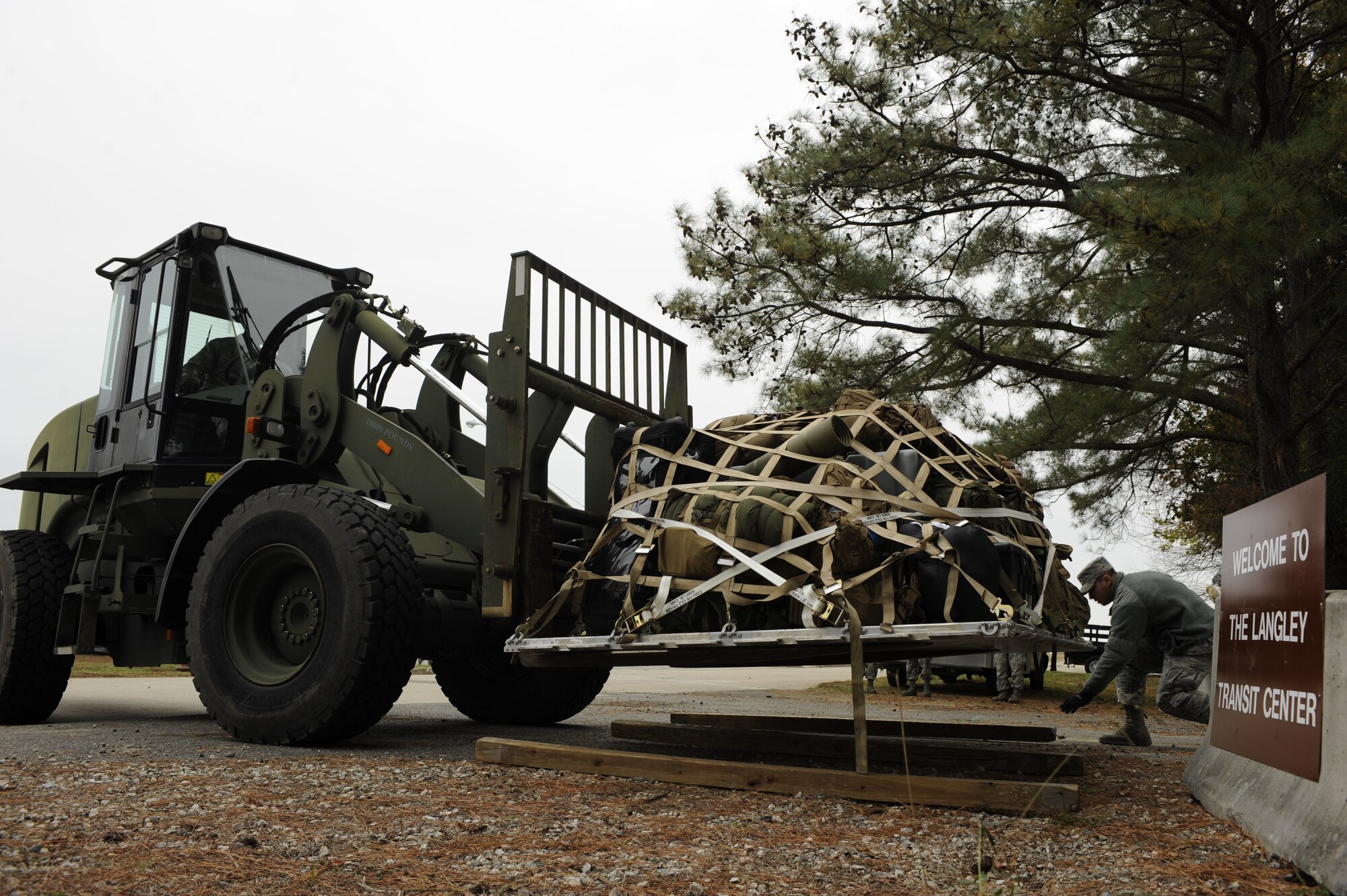 U.S. Air Force Airmen unload pallets of luggage and supplies at Joint Base Langley-Eustis’ Langley Transit Center, Va., Nov. 13, 2014. The supplies belong to Service members stationed in the Northeast region of the U.S., who returned from Operation United Assistance in West Africa. (U.S. Air Force photo by Staff Sgt. Natasha Stannard/Released)