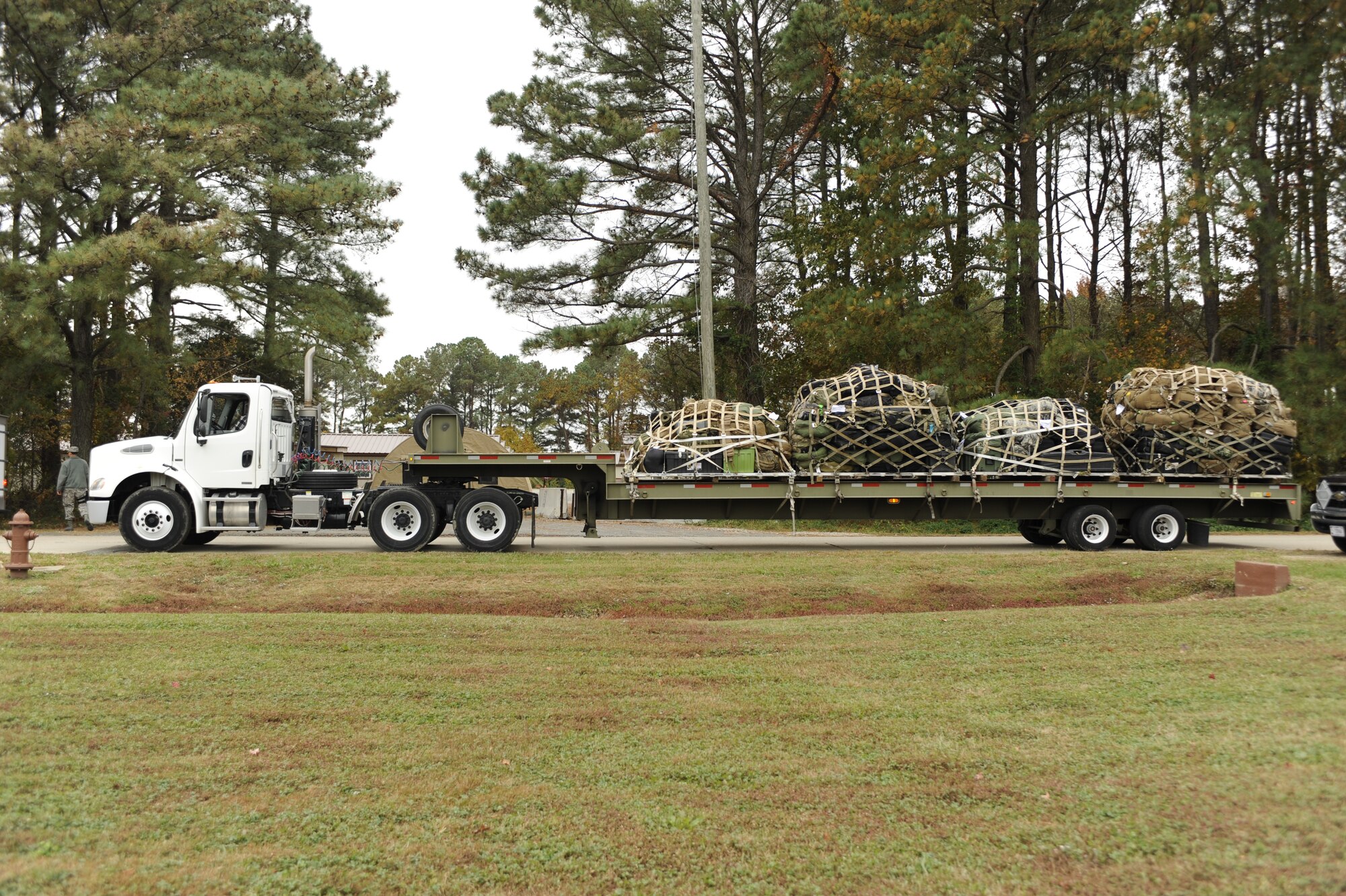 A truck transports U.S. Service members’ supplies and luggage to Joint Base Langley-Eustis’ Langley Transit Center, Va., Nov. 13, 2014. The Service members are returning from Operation United Assistance in West Africa where they supported Operation United Assistance, and will be staying at the center for 21-days for controlled monitoring of the Ebola Virus Disease. While closed-off from the rest of the general population, the center offers Service members recreation areas, fitness areas and other amenities. (U.S. Air Force photo by Staff Sgt. Natasha Stannard/Released)