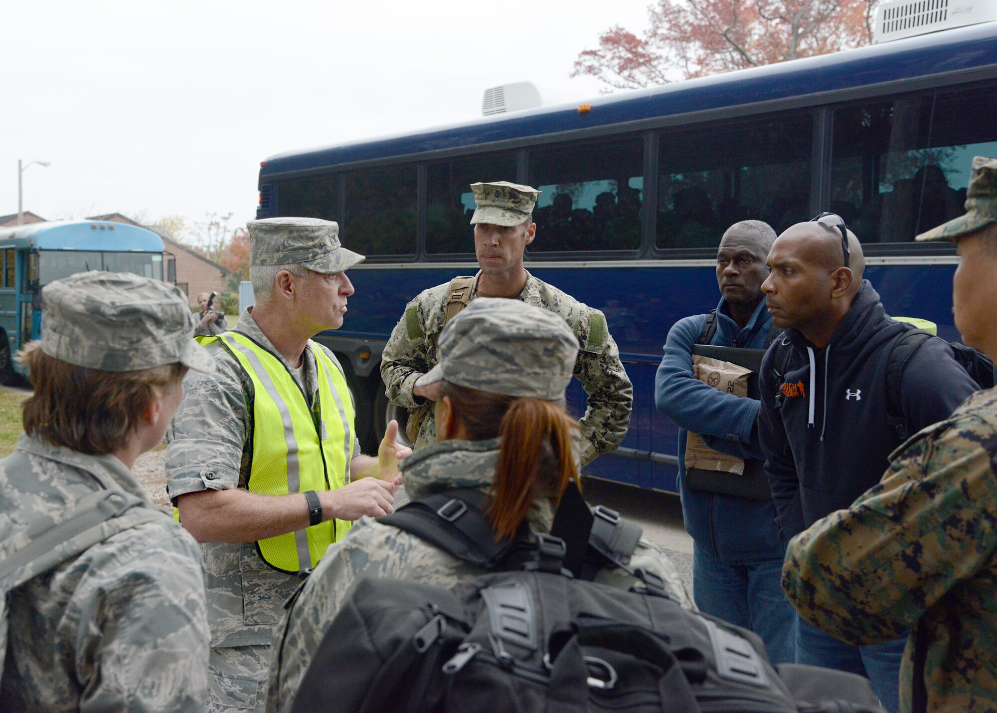 U.S. Air Force Col. (Dr.) Wayne Pritt, 633rd Medical Group commander (wearing vest), speaks to Service members arriving at the Langley Transit Center at Langley Air Force Base, Va., Nov. 13, 2014. The arriving personnel were deployed to combat Ebola in West Africa as part of Operation United Assistance, and will undergo a 21-day controlled monitoring period at the transit center before returning to their home stations. (U.S. Air Force photo by Staff Sgt. Jason J. Brown/Released)