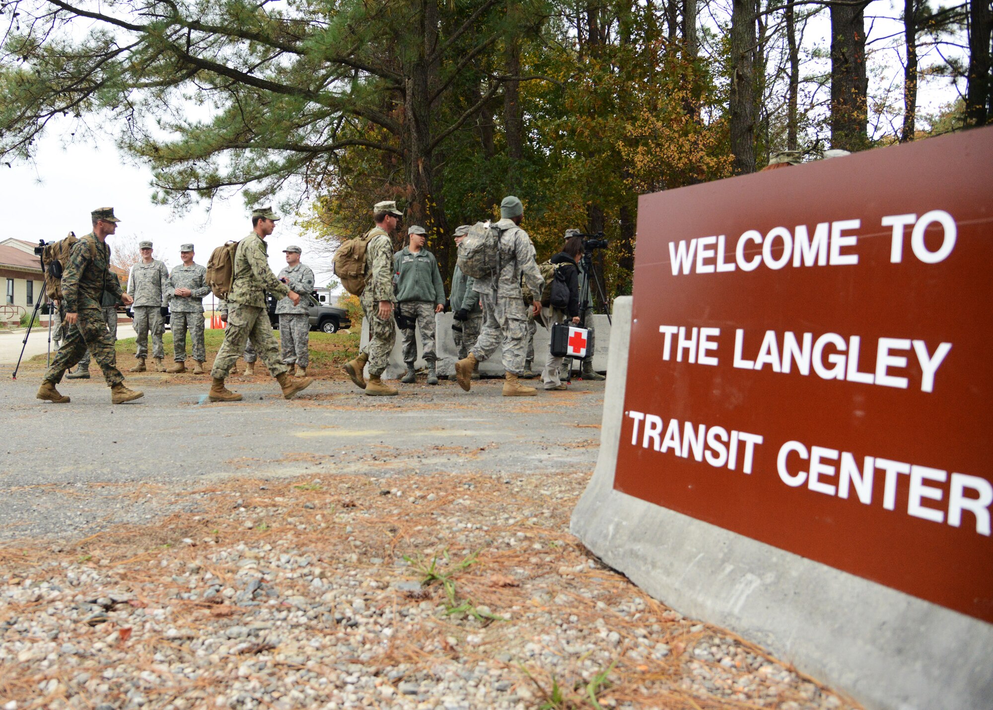 U.S. Service members arrive at the Langley Transit Center at Langley Air Force Base, Va., Nov. 13, 2014. Ninety Service members from multiple branches of the Armed Forces will undergo a 21-day controlled monitoring period at the transit center after returning from fighting the spread of Ebola in West Africa in support of Operation United Assistance. (U.S. Air Force photo by Staff Sgt. Jason J. Brown/Released)