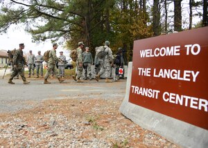 U.S. Service members arrive at the Langley Transit Center at Langley Air Force Base, Va., Nov. 13, 2014. Ninety Service members from multiple branches of the Armed Forces will undergo a 21-day controlled monitoring period at the transit center after returning from fighting the spread of Ebola in West Africa in support of Operation United Assistance. (U.S. Air Force photo by Staff Sgt. Jason J. Brown/Released)
