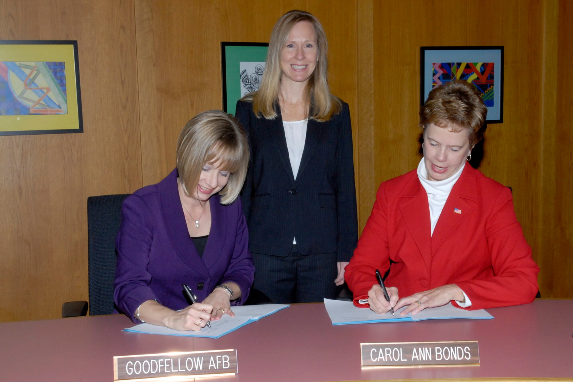 SAN ANGELO, Texas – Toni L. Hansen, 17th Force Support Squadron Director, Debra L. Scougall, 17th FSS Airman and Family Readiness Center school liaison officer, and Dr. Carol A. Bonds, San Angelo Independent School District superintendent, sign a Memorandum of Understanding at the SAISD Administration Building Nov. 13. The MOU is for a partnership between the A&FRC and SAISD on the creation and management of a student sponsorship program called Help a New Kid Succeed. A selection of first- through eighth-graders at Glenmore Elementary School and Glen Middle School will train as sponsors for incoming new students. (U.S. Air Force photo/ Lou Czarnecki) 