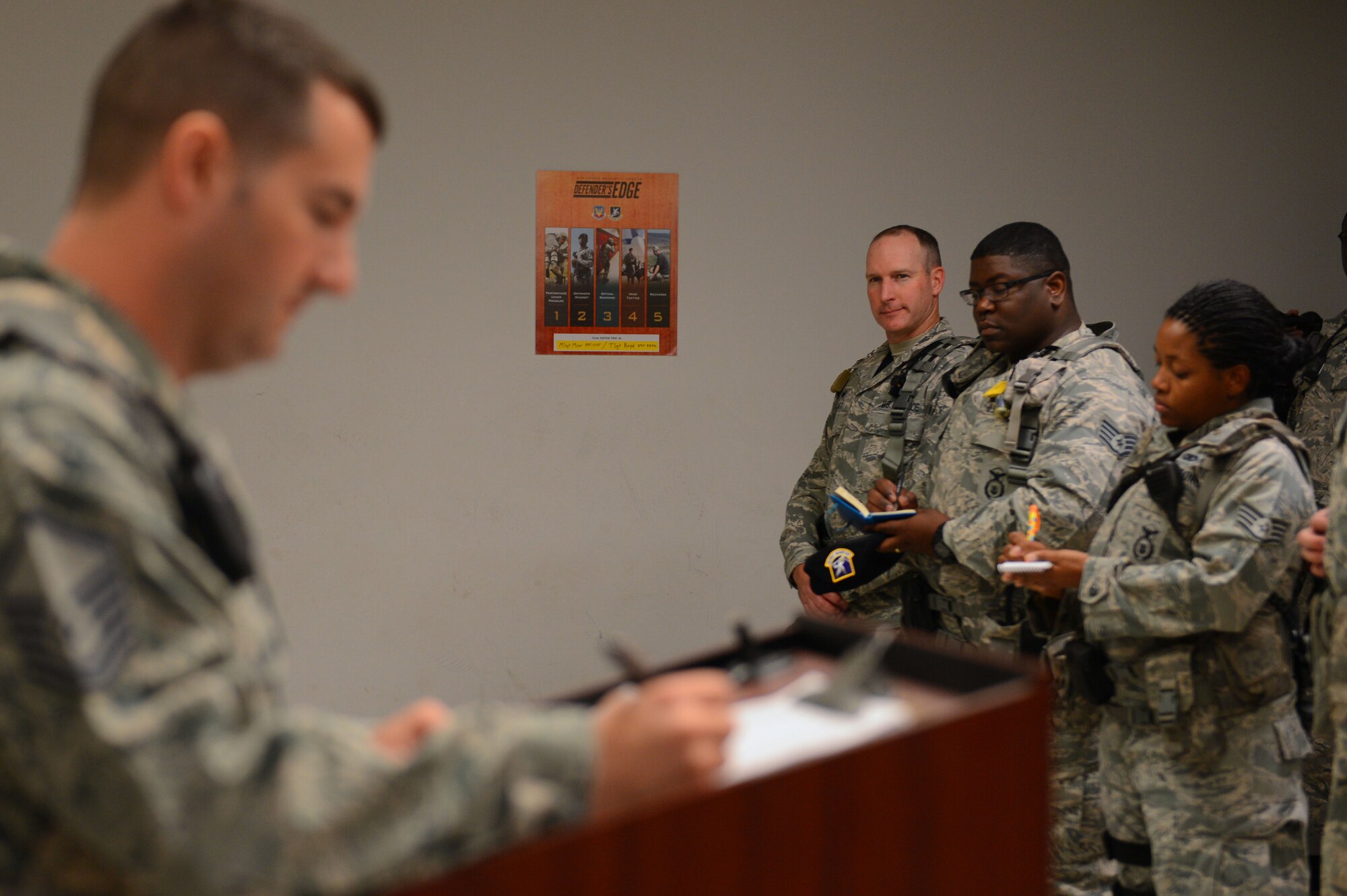 U.S. Air Force Col. Stephen Jost, 20th Fighter Wing commander, checks identification cards at the main gate at Shaw Air Force Base, S.C., Oct. 27, 2014. Jost checked ID cards during the morning traffic rush as part of his 12-hour “Behind the Scenes” job shadowing opportunity with the 20th Security Forces Squadron. (U.S. Air Force photo by Senior Airman Tabatha Zarrella/Released)