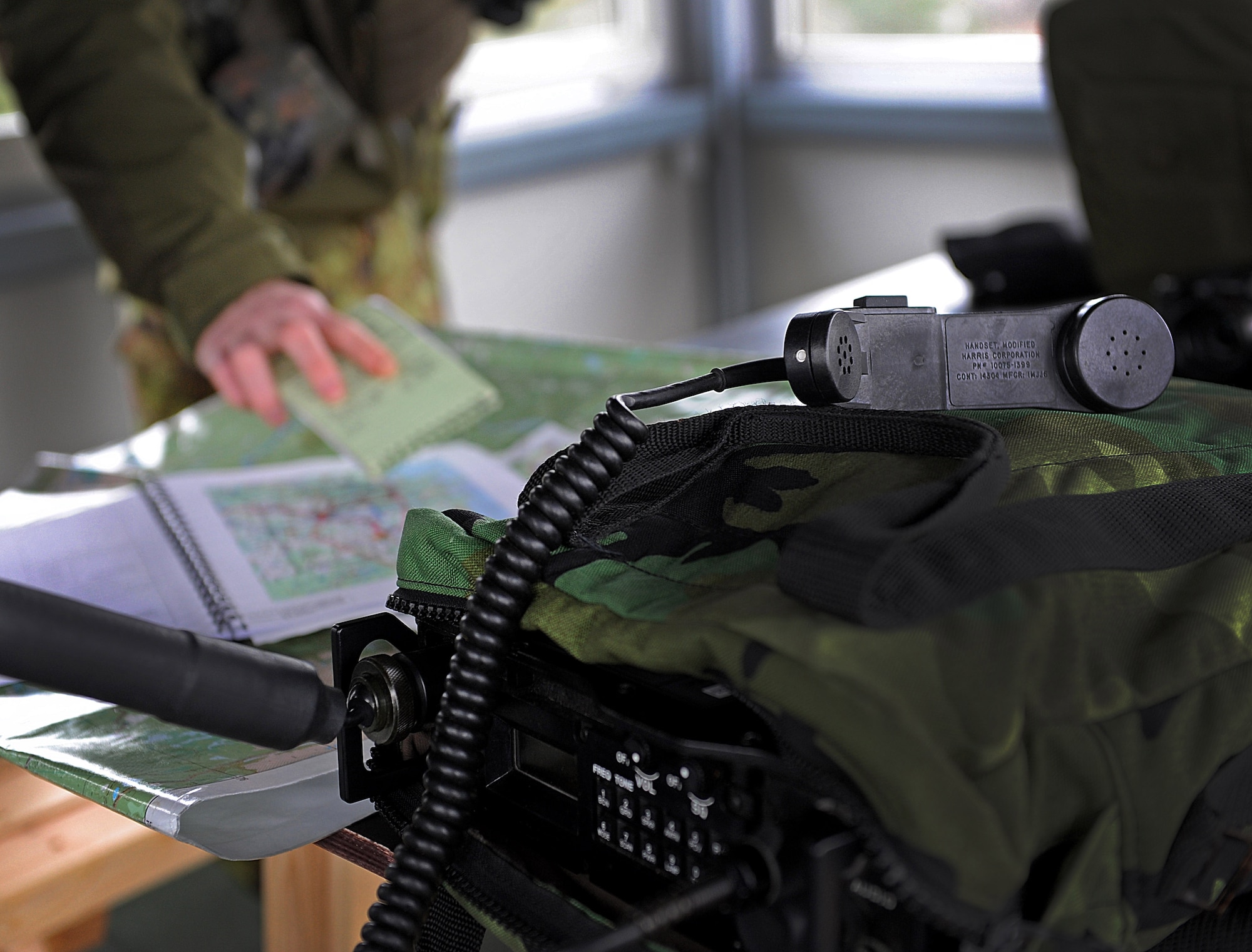 An Estonian air force joint tactical air controller listens to a pilot as he gives his coordinates over a radio Nov. 13, 2014, near Tapa, Estonia. During the air-to-ground training, two 31st Fighter Wing F-16 Fighting Falcons worked with the Estonian air force to refine their ability to better work alongside with NATO and U.S forces. (U.S. Air Force photo/Senior Airman Matthew Lotz) 