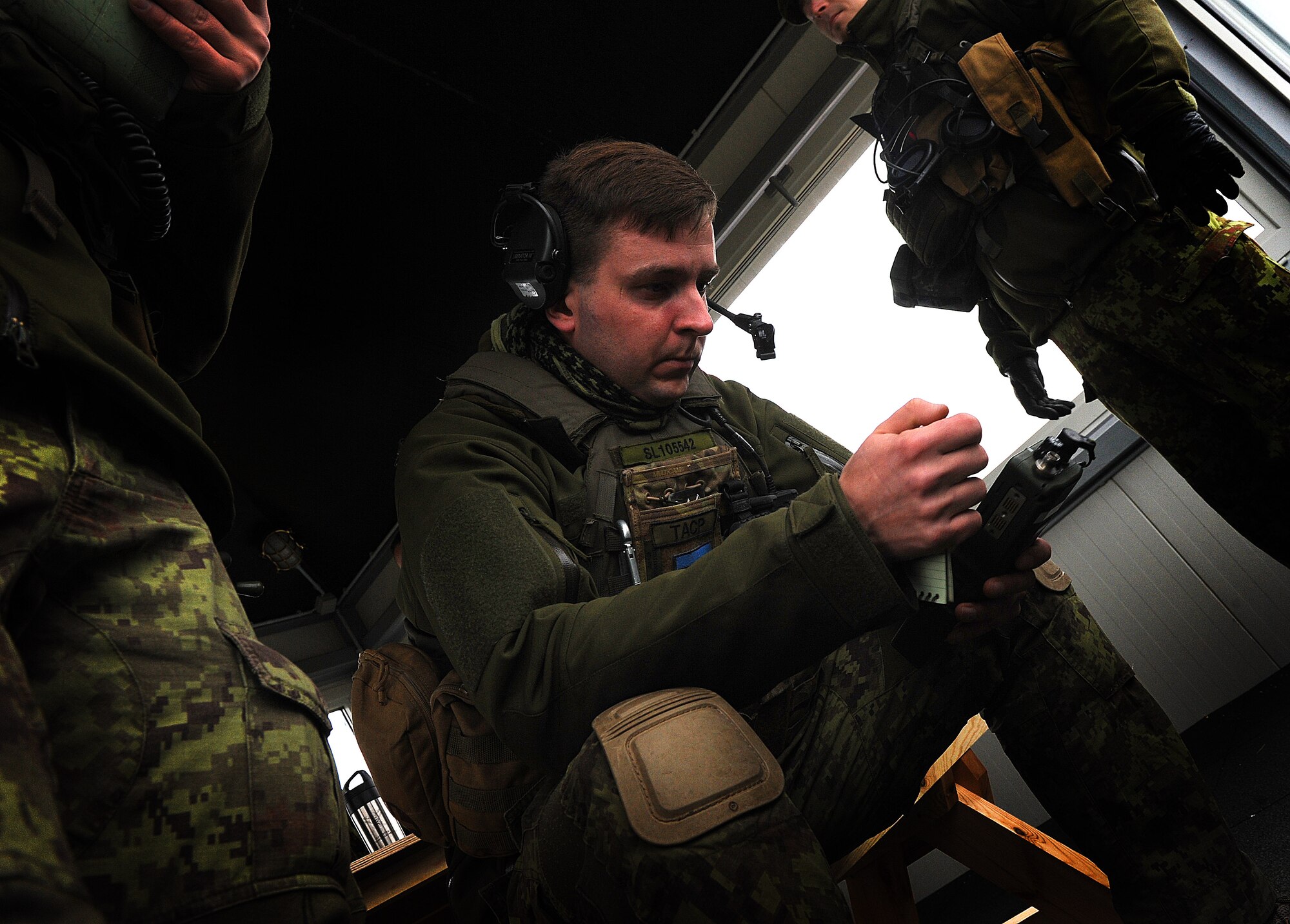 An Estonian air force joint tactical air controller, checks his radio before training Nov. 13, 2014, near Tapa, Estonia. The joint-training is designed to provide a broad range of training opportunities between NATO allies. (U.S. Air Force photo/Senior Airman Matthew Lotz)