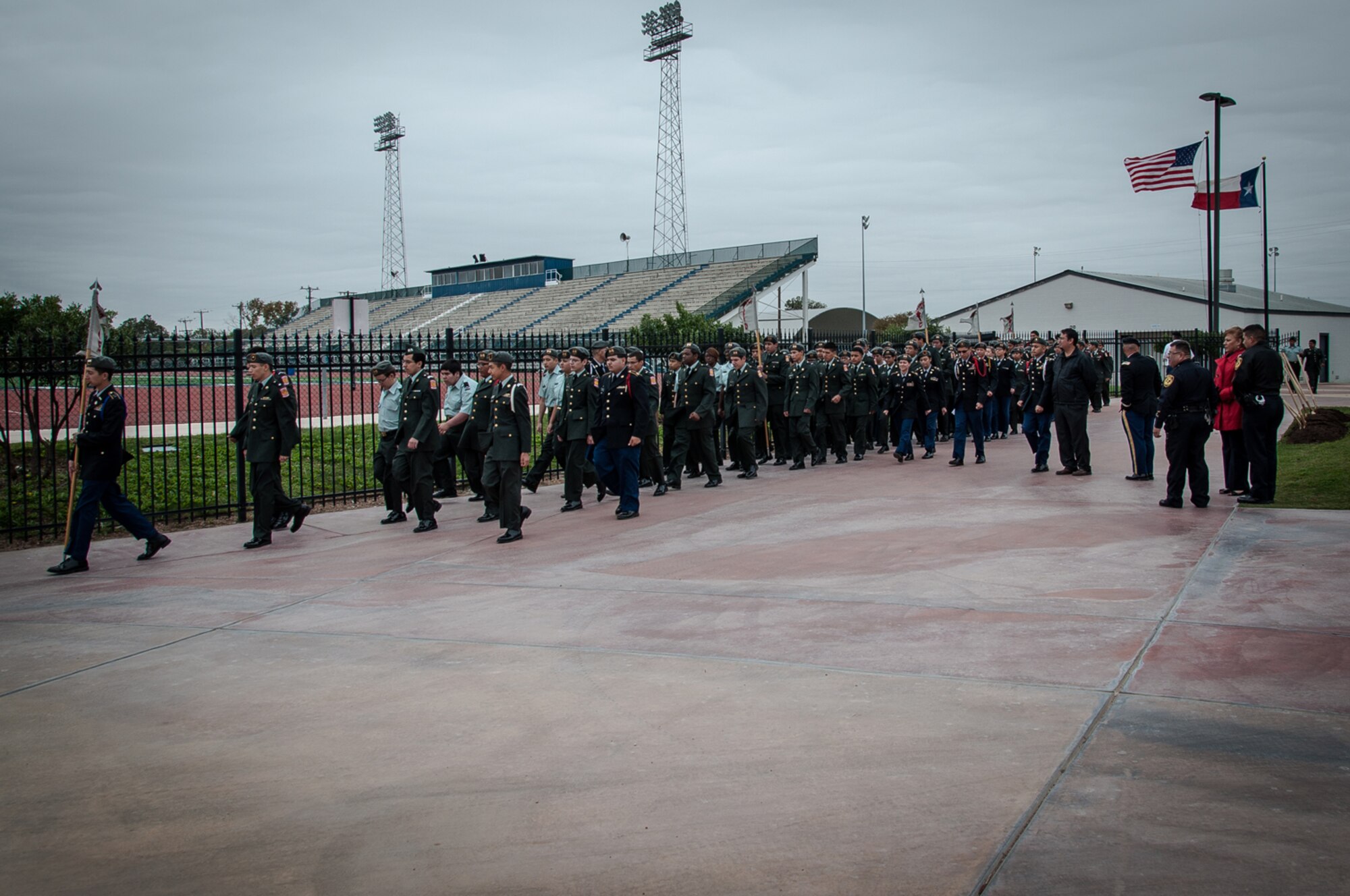 The local JROTC unit marches off after a groundbreaking ceremony held at South San Antonio High School, Nov. 11, 2014, for a veteran’s memorial that will be erected on the campus later next year. The memorial is meant to commemorate native San Antonio veterans, from across the military services, who have lost their lives serving their country. (U.S. Air Force photo by 1st Lt. Jose R. Davis)