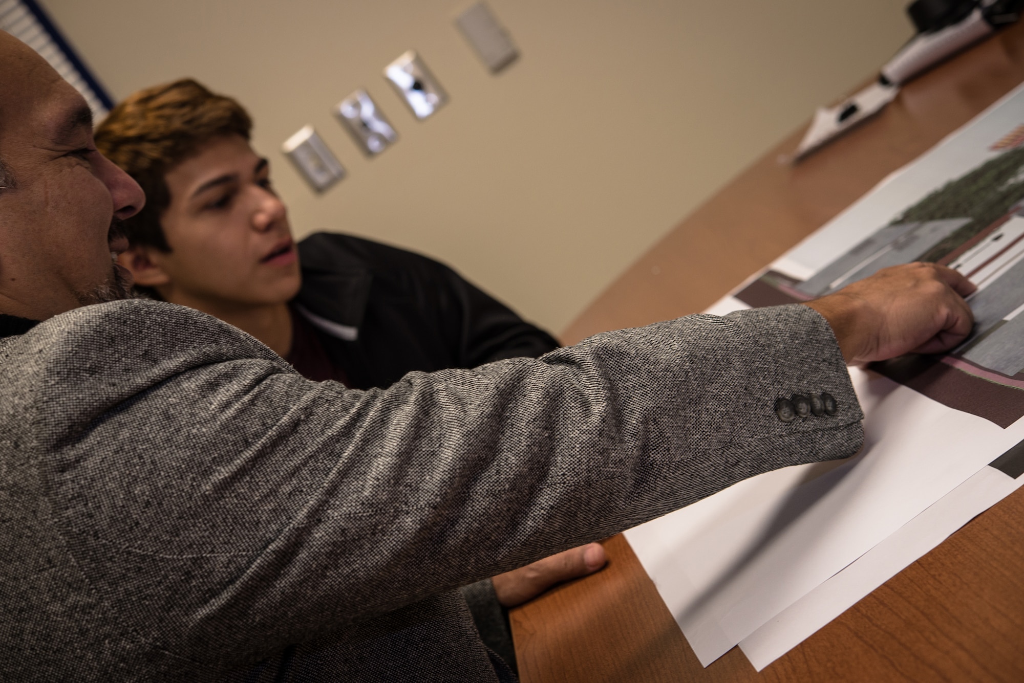 Architect Jorge Flores mentors Julio Zamora, a senior at South San Antonio High School, Nov. 6, 2014, on Zamora’s winning architectural design for a veteran’s memorial that will be built on the campus. The memorial is meant to commemorate native San Antonio veterans, from across the military services, who have lost their lives serving their country. (U.S. Air Force photo by 1st Lt. Jose R. Davis)