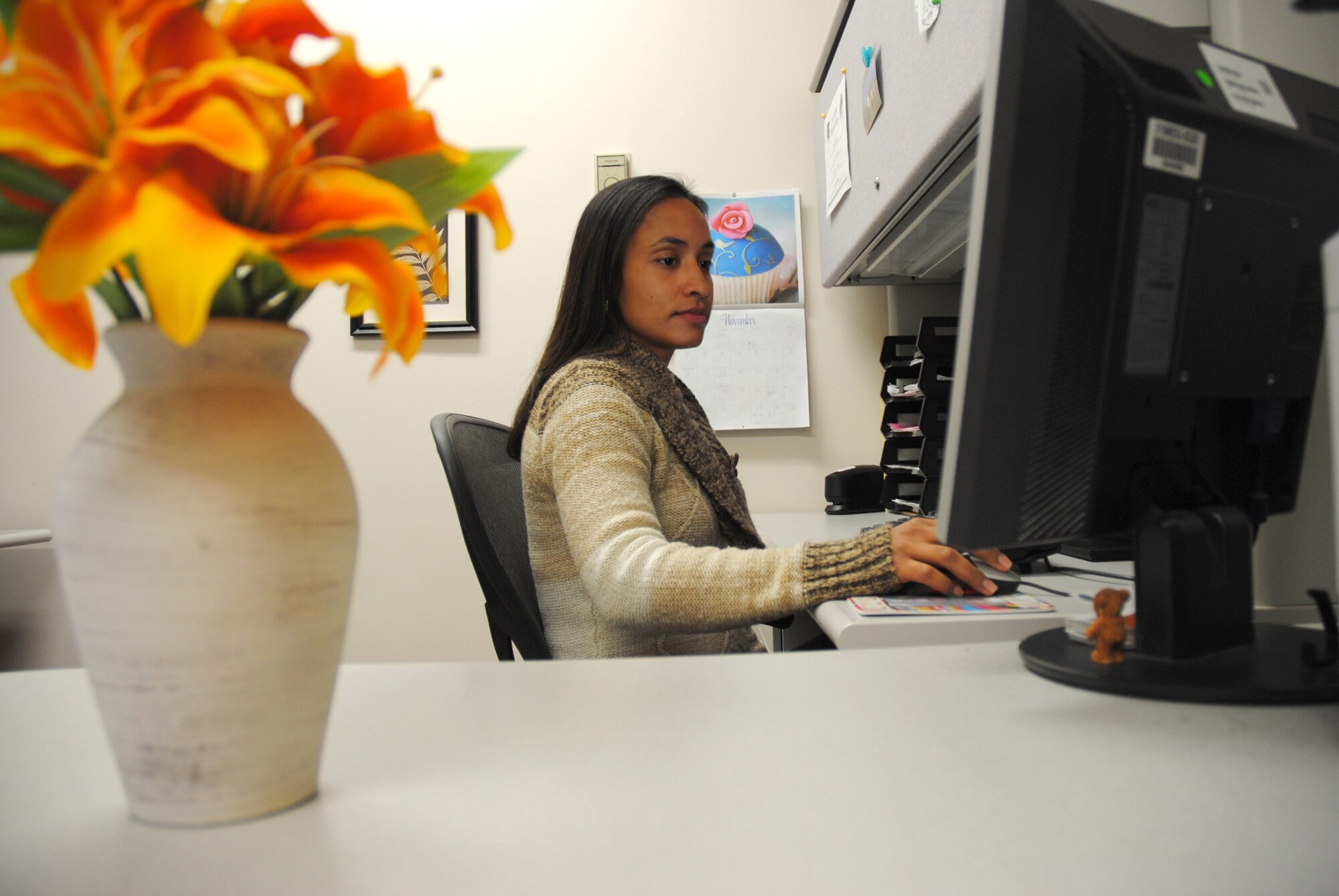 Yesenia McPhaul, 319th Medical Operation Squadron medical support assistant, answers e-mail from her work station in the Medical Treatment Facility on Grand Forks Air Force Base, N.D., Nov. 7, 2014. The 33-year-old from Rio Piedras, Puerto Rico, was named the Grand Forks AFB Warrior of the Week for the second week of November 2014. (U.S. Air Force photo/Staff Sgt. Luis Loza Gutierrez)