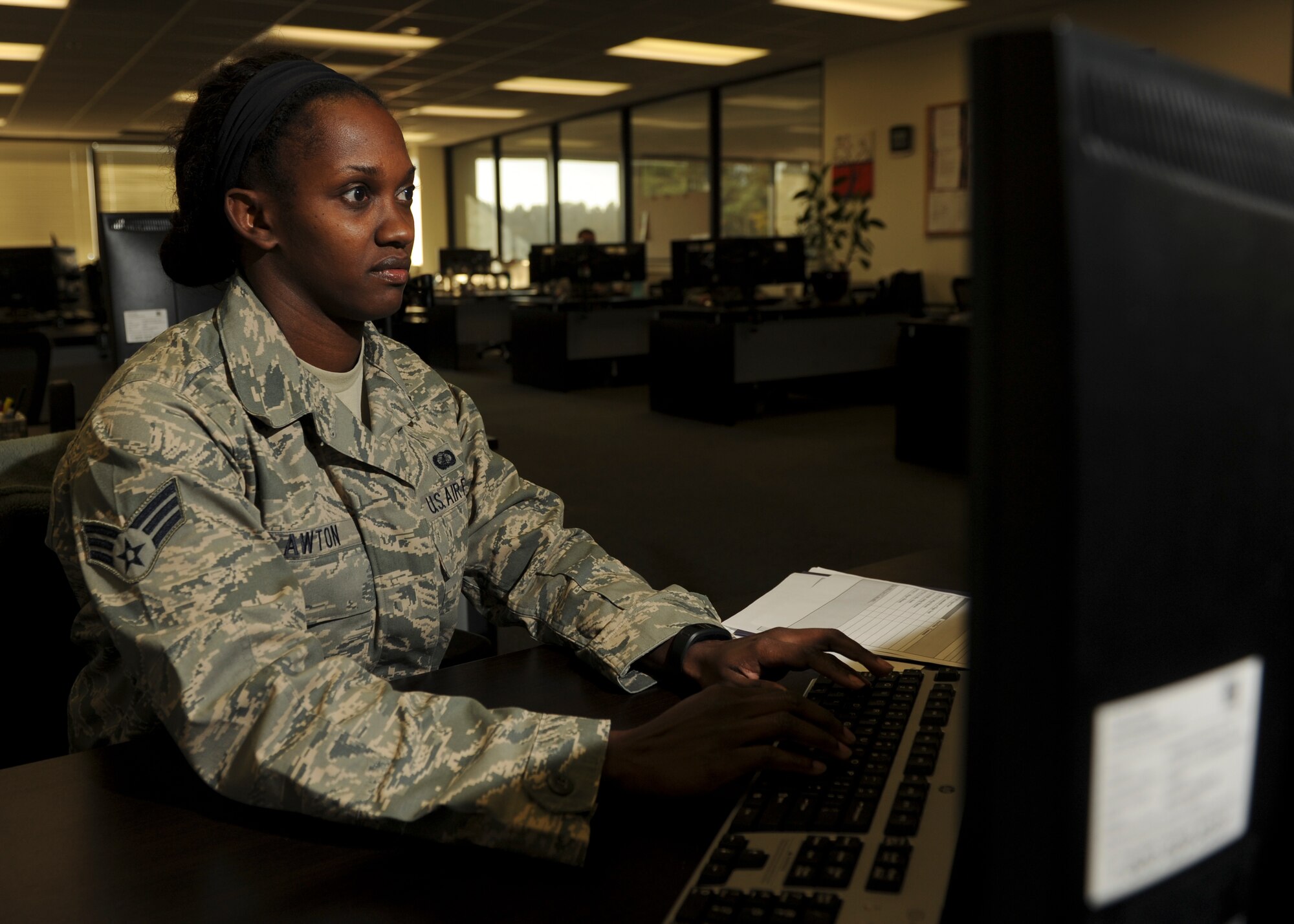 Col. Patrick Rhatigan, 19th Airlift Wing commander, and Chief Master Sgt. Rhonda Buening, 19th AW command chief, congratulate Senior Airman Jeaniae Lawton, a 19th Comptroller Squadron financial analyst, for her selection as Combat Airlifter of the Week Nov. 10, 2014, at Little Rock Air Force Base, Ark. Lawton, a Detroit, Mich. native, was responsible for $800 thousand being returned back to the 19th AW to help fund the repair of the base pool. (U.S. Air Force photo by Airman 1st Class Scott Poe)                  