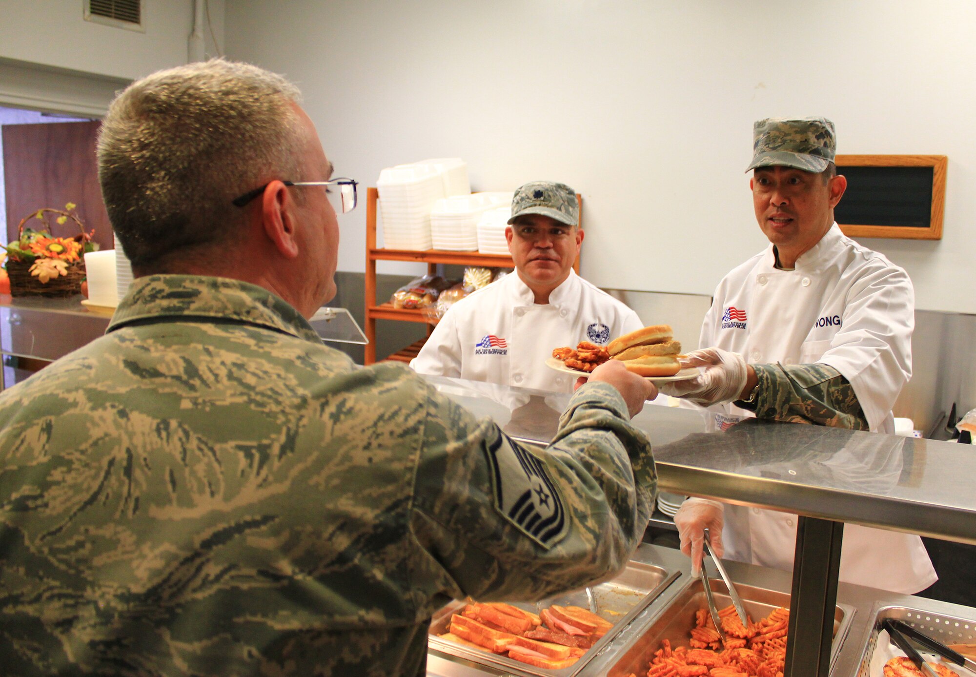 WRIGHT-PATTERSON AIR FORCE BASE, Ohio – Chief Master Sgt. Brian C. L. Wong, Command Chief Master Sergeant, Fourth Air Force, March Air Reserve Base, California, serves lunch to 445th Airlift Wing Airmen at the Pitsenbarger Dining Facility during the Nov. 2 unit training assembly. Chief Wong and Brig. Gen. John C. Flournoy Jr., Fourth Air Force Commander, met with the men and women of the 445th while visiting various units Oct. 31-Nov. 2. The two also visited with attendees of the wing’s Employer Appreciation Day Nov 1. (U.S. Air Force photo/Tech. Sgt. Patrick O’Reilly)