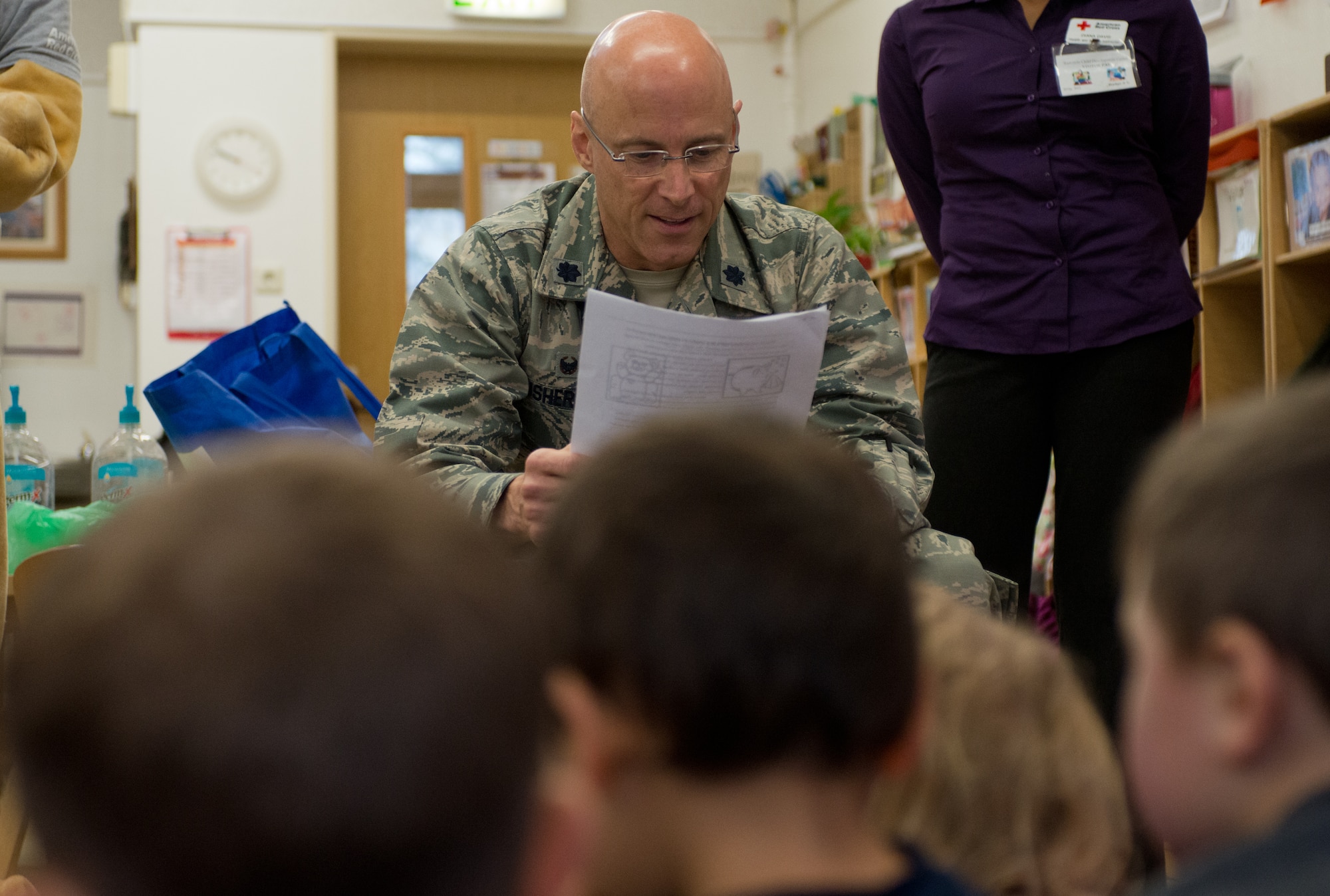 Lt. Col. Ausherman Thomas, 86th Force Support Squadron commander, reads an excerpt from a Scrubby Bear story to children at the Ramstein Child Development Center Nov. 13, 2014, at Ramstein Air Base, Germany. The Scrubby Bear Program is led by the Red Cross to help educate children on the importance of personal hygiene. (U.S. Air Force photo/ Senior Airman Jonathan Stefanko)