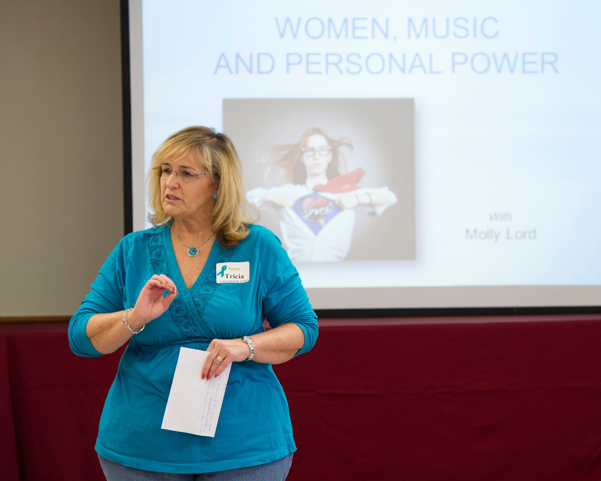 Patricia Gragg, 45th Space Wing Sexual Assault Response Coordinator, welcomes members of Team Patrick-Cape to a workshop geared toward women, music & personal power, Nov. 7, 2014, at Patrick Air Force Base, Fla. In conjunction with the workshop, Team Patrick-Cape was authorized to wear denim jeans in observance of Denim Day, to recognize the importance of preventing sexual assault. (U.S. Air Force photo/Matthew Jurgens) 