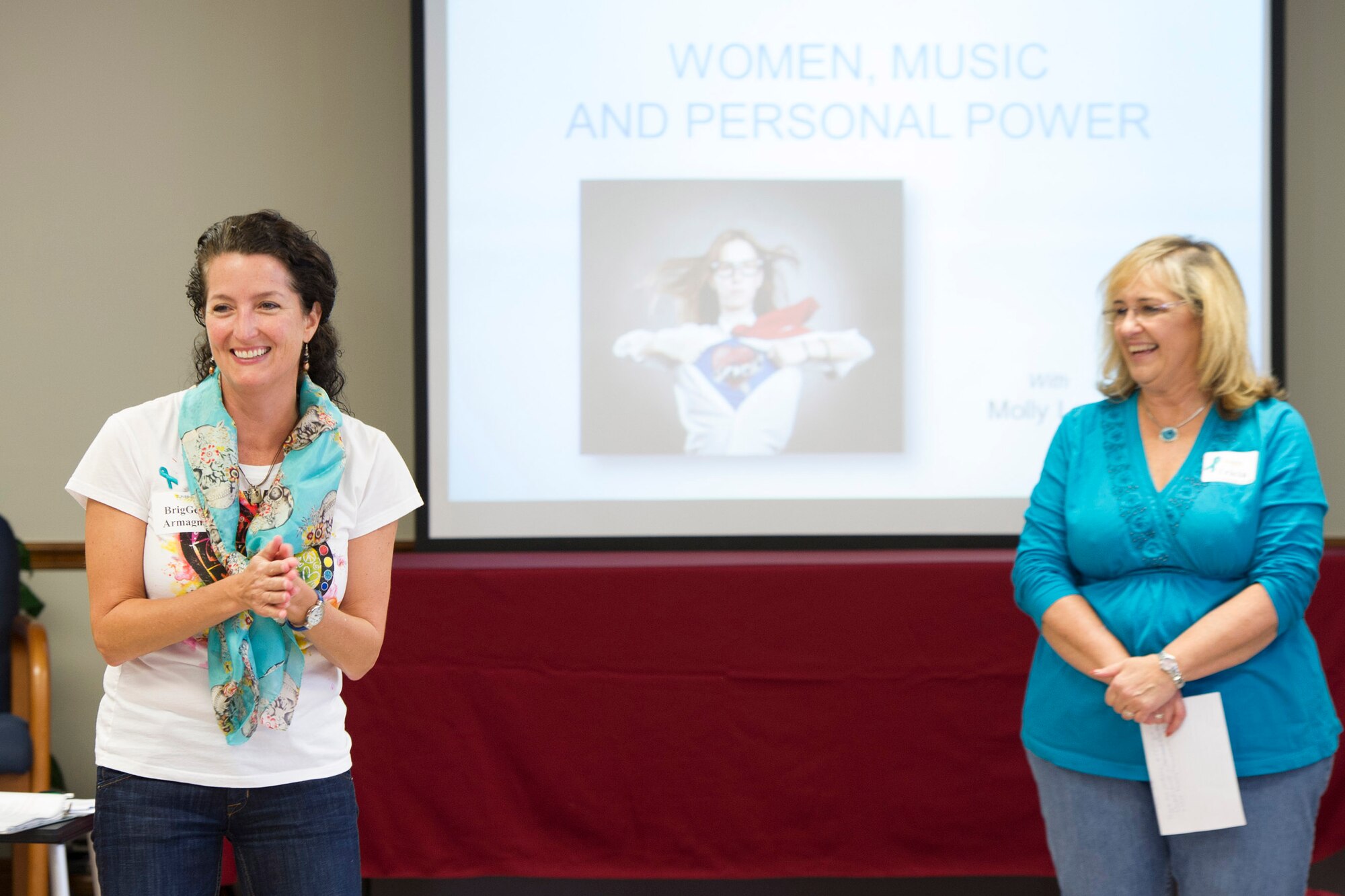 (right) Patricia Gragg, 45th Space Wing Sexual Assault Response Coordinator, welcomes Brig. Gen. Nina Armagno, 45th Space Wing commander, and guests, to a workshop geared toward women, music & personal power, Nov. 7, 2014, at Patrick Air Force Base, Fla. In conjunction with the workshop, Team Patrick-Cape was authorized to wear denim jeans in observance of Denim Day, to recognize the importance of preventing sexual assault. (U.S. Air Force photo/Matthew Jurgens) 