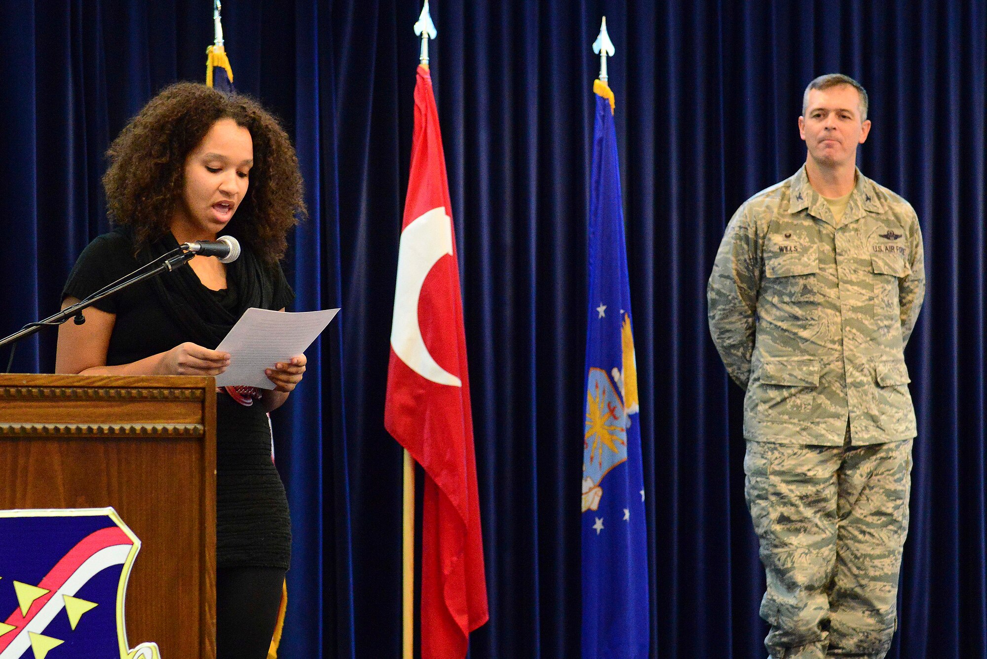 Trinity, 17, daughter of Senior Master Sgt. Angela Stout, 39th Comptroller Squadron superintendent, reads her Veterans Day essay Nov. 10, 2014, Incirlik Air Base, Turkey. Trinity was one of four contestants who entered original written works into the Veterans Day essay contest. (U.S. Air Force photo by Staff Sgt. Eboni Reams)
