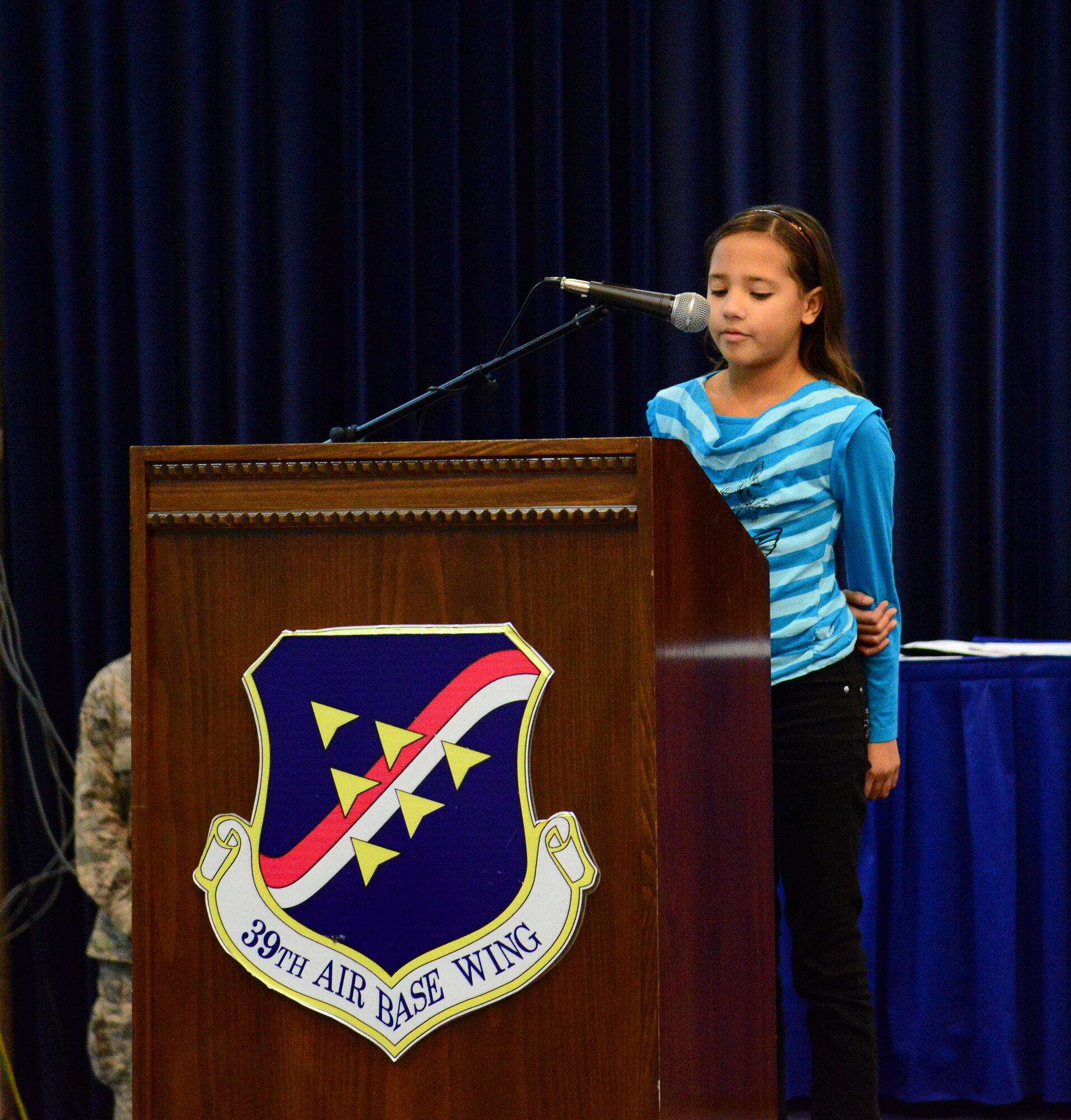 Keilani, 9, daughter of Tech. Sgt. Max Gonzales, 39th Force Support Squadron manpower analyst, reads her Veterans Day essay Nov. 10, 2014, Incirlik Air Base, Turkey. Keilani was one of four contestants who entered original written works into the Veterans Day essay contest. (U.S. Air Force photo by Staff Sgt. Eboni Reams)