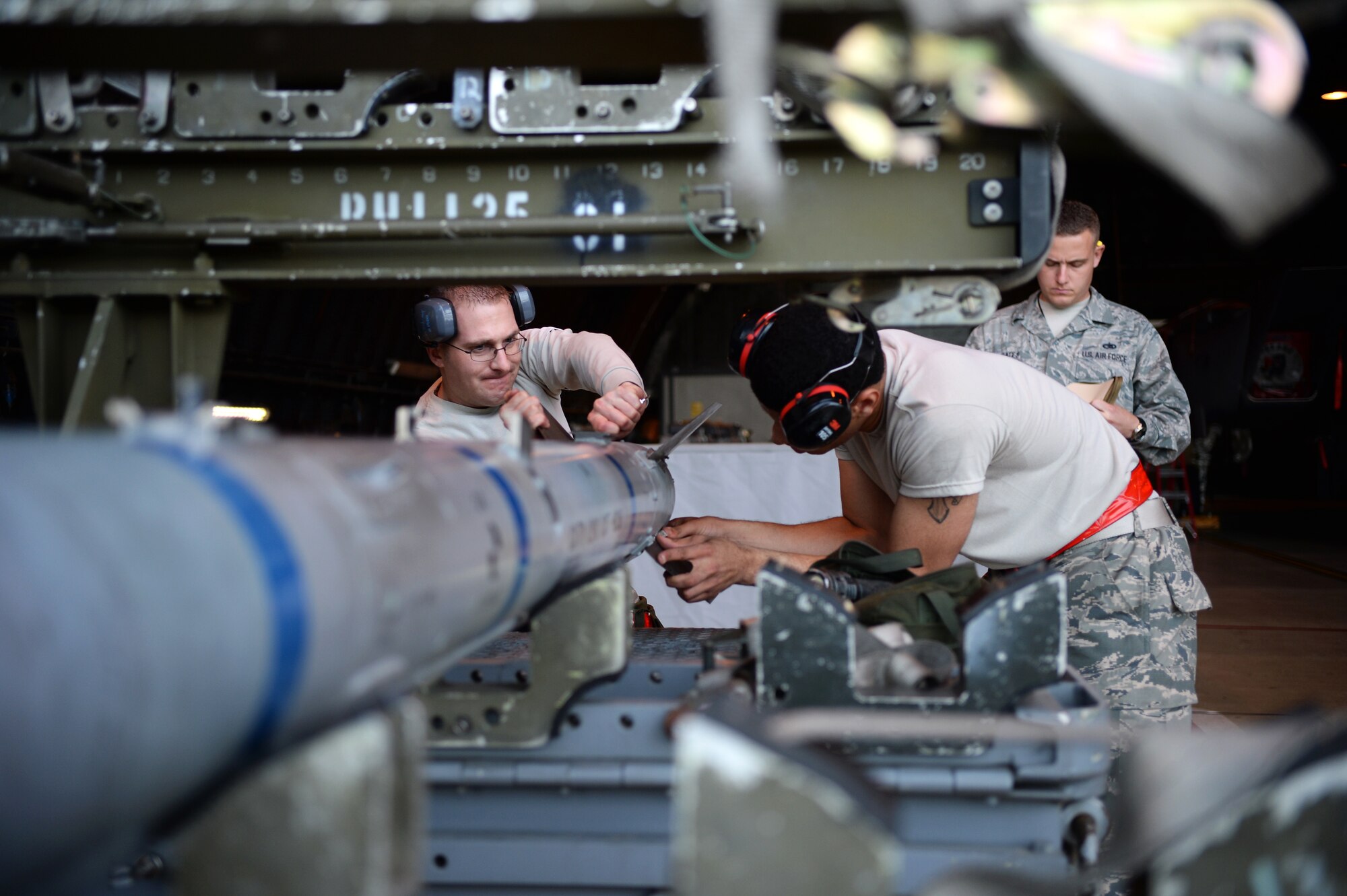 Tech. Sgt. Michael Delucy, left, and Airman 1st Class Dante Gibson, both 494th Aircraft Maintenance Unit load crew members, prepare to transport an Air Intercept Missile-9 during a quarterly weapons competition at Royal Air Force Lakenheath, England, Oct. 31, 2014. Load crew competitions promote a safe, competitive environment where Airmen display their skills and the ability to apply what they’ve learned in training. (U.S. Air Force photo by Staff Sgt. Emerson Nuñez/Released)