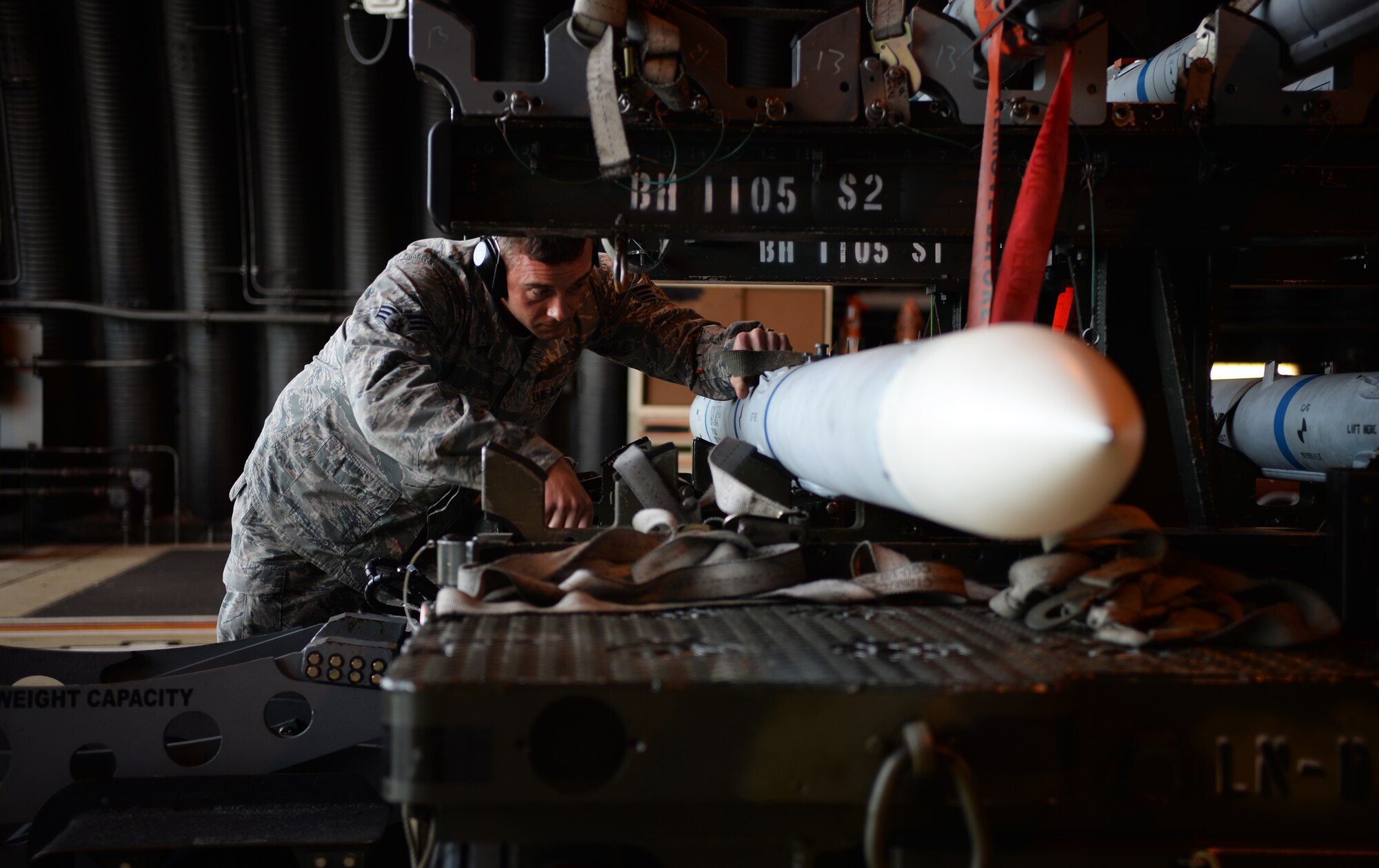 Senior Airman Leo Baum, 493rd Aircraft Maintenance Unit load crew member, prepares to transport an Air Intercept Missile-9 during a quarterly weapons competition at Royal Air Force Lakenheath, England, Oct. 31, 2014. Load crew competitions give personnel the opportunity to display their war-fighting skills and highlights the best weapons load crew for the quarter. (U.S. Air Force photo by Staff Sgt. Emerson Nuñez/Released)
