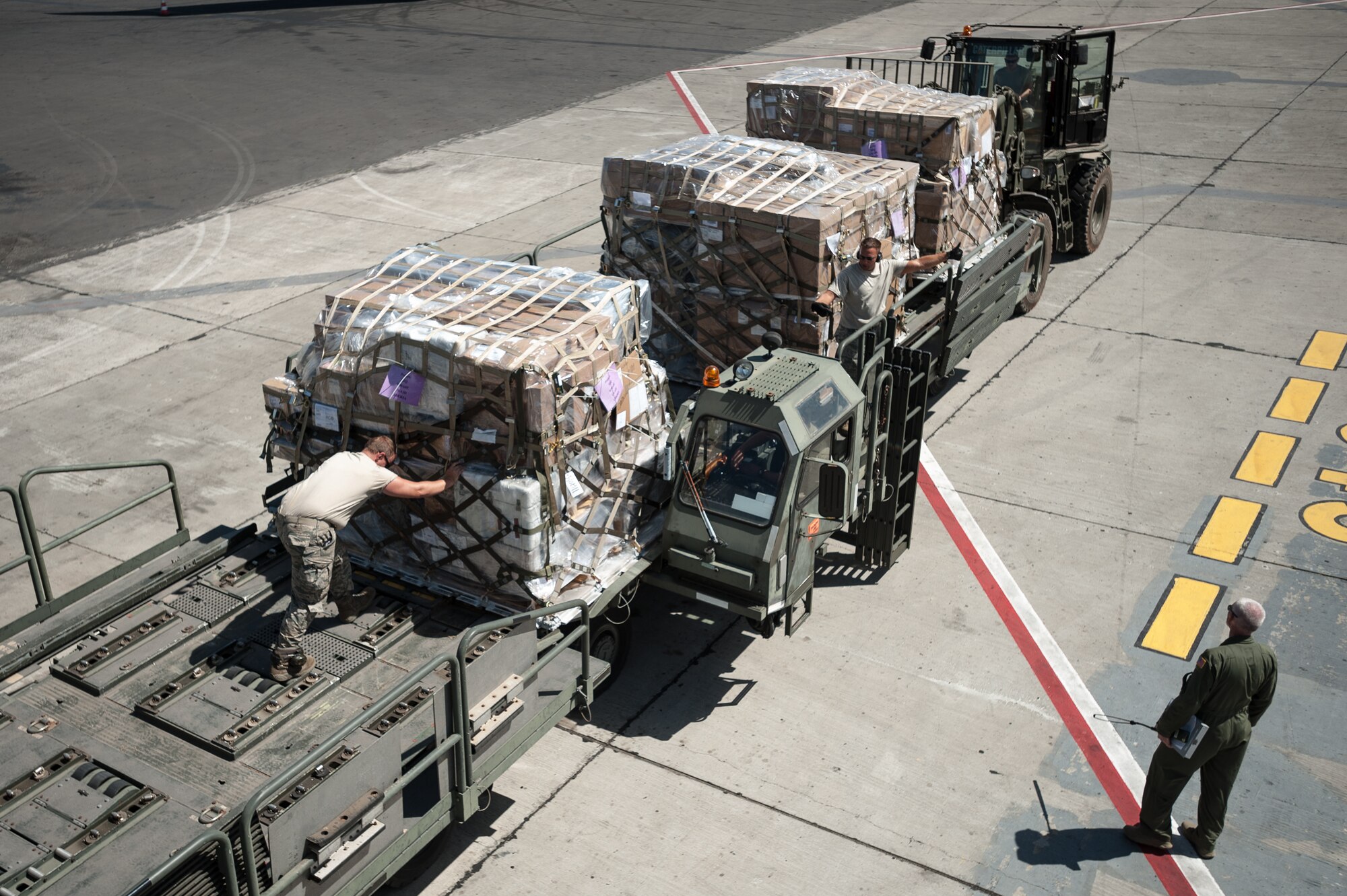 Aerial porters from the Kentucky Air National Guard’s 123rd Contingency Response Group offload humanitarian cargo from a U.S. Air Force KC-10 aircraft at Léopold Sédar Senghor International Airport in Dakar, Senegal, Nov. 12, 2014. The Kentucky Airmen will stage the cargo in Senegal before transloading it to U.S. Air Force C-130J aircraft for delivery into Monrovia, Liberia, in support of Operation United Assistance, the U.S. Agency for International Development-led, whole-of-government effort to contain the Ebola virus outbreak in West Africa. (U.S. Air National Guard photo by Maj. Dale Greer)