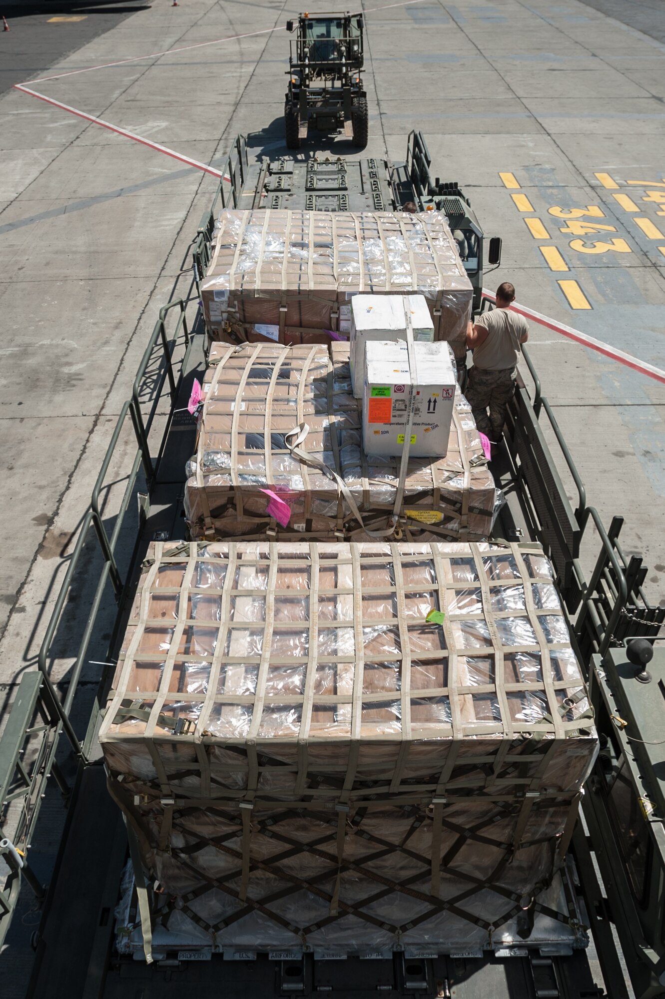 Aerial porters from the Kentucky Air National Guard’s 123rd Contingency Response Group offload humanitarian cargo from a U.S. Air Force KC-10 aircraft at Léopold Sédar Senghor International Airport in Dakar, Senegal, Nov. 12, 2014. The Kentucky Airmen will stage the cargo in Senegal before transloading it to U.S. Air Force C-130J aircraft for delivery into Monrovia, Liberia, in support of Operation United Assistance, the U.S. Agency for International Development-led, whole-of-government effort to contain the Ebola virus outbreak in West Africa. (U.S. Air National Guard photo by Maj. Dale Greer)
