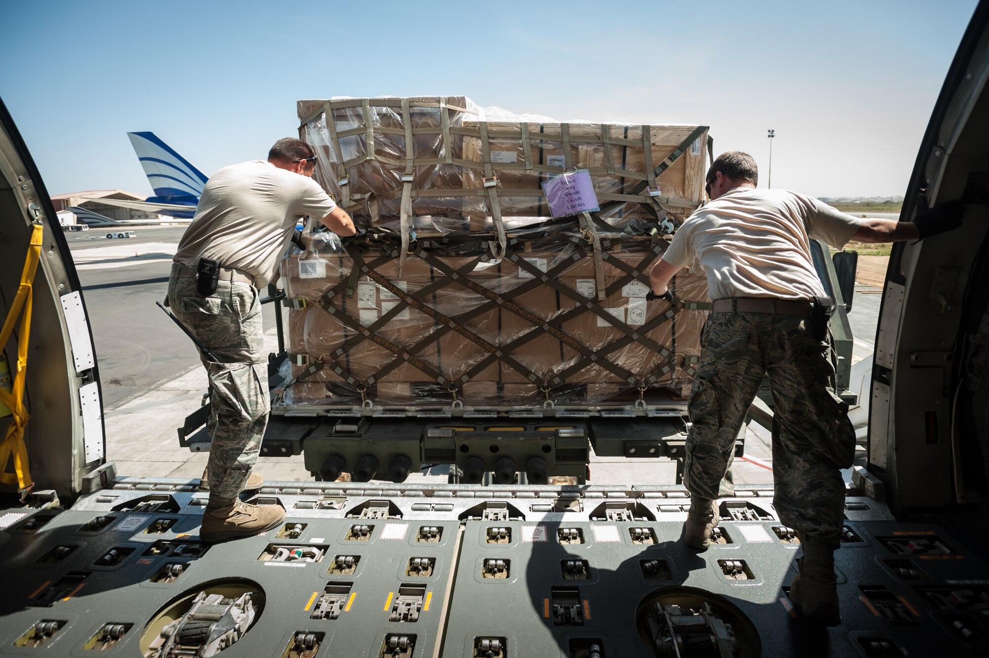 Aerial porters from the Kentucky Air National Guard’s 123rd Contingency Response Group offload pallets of humanitarian aid from a U.S. Air Force KC-10 aircraft onto a Halverson cargo-handling vehicle at Léopold Sédar Senghor International Airport in Dakar, Senegal, Nov. 12, 2014. The Kentucky Airmen will stage the cargo in Senegal before transloading it to U.S. Air Force C-130J aircraft for delivery into Monrovia, Liberia, in support of Operation United Assistance, the U.S. Agency for International Development-led, whole-of-government effort to contain the Ebola virus outbreak in West Africa. (U.S. Air National Guard photo by Maj. Dale Greer)