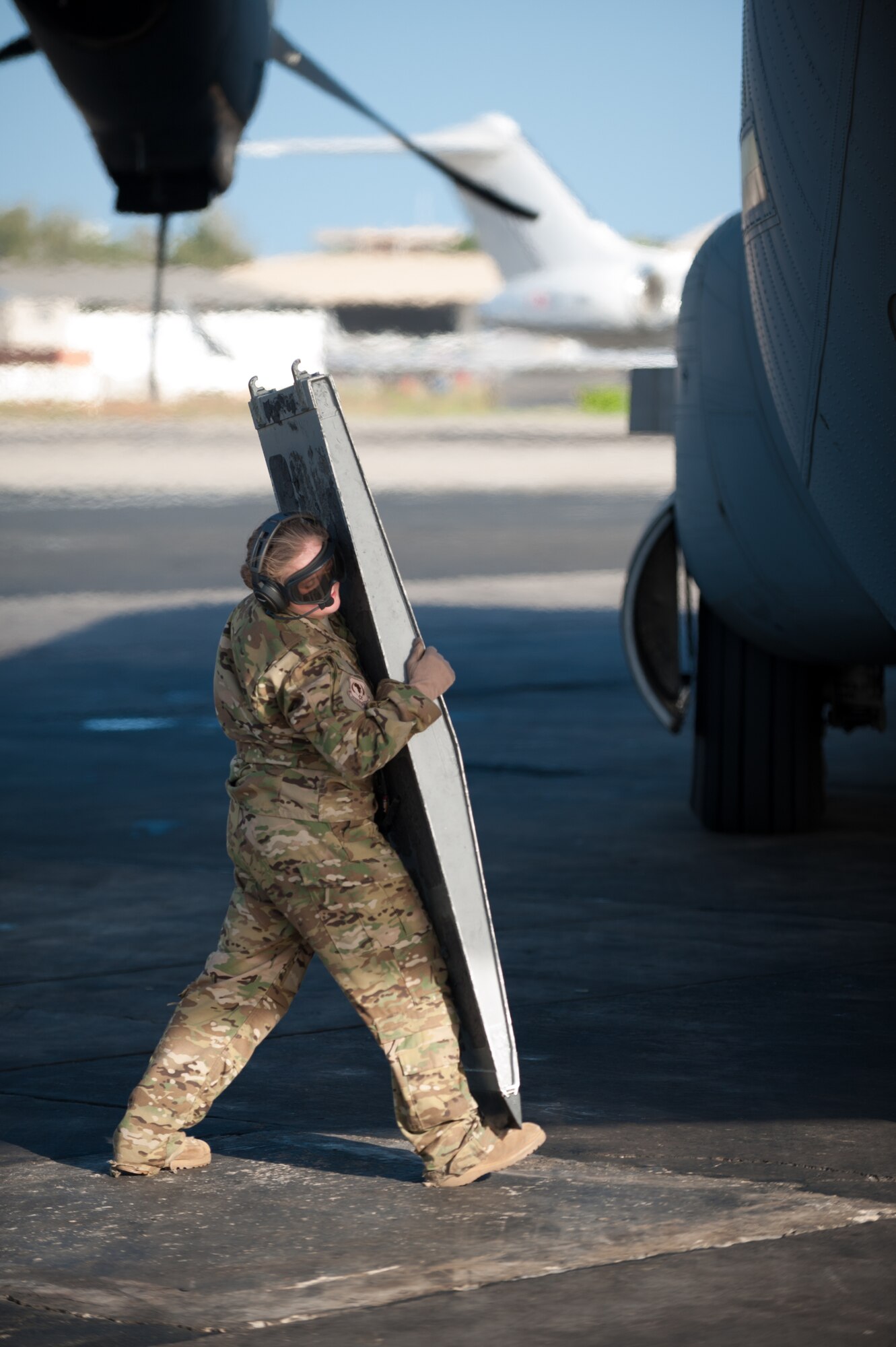 U.S. Air Force Staff Sgt. Kassondra Cline, a loadmaster for the 787th Air Expeditionary Squadron, prepares to position a loading ramp on a U.S. Air Force C-130J aircraft at Léopold Sédar Senghor International Airport in Dakar, Senegal, Nov. 11, 2014. The aircraft and crew, from Dyess Air Force Base Texas, are deployed to Senegal to fly humanitarian aid and troop-support equipment into Monrovia, Liberia, in support of Operation United Assistance, the U.S. Agency for International Development-led, whole-of-government effort to contain the Ebola virus outbreak in West Africa. (U.S. Air National Guard photo by Maj. Dale Greer)