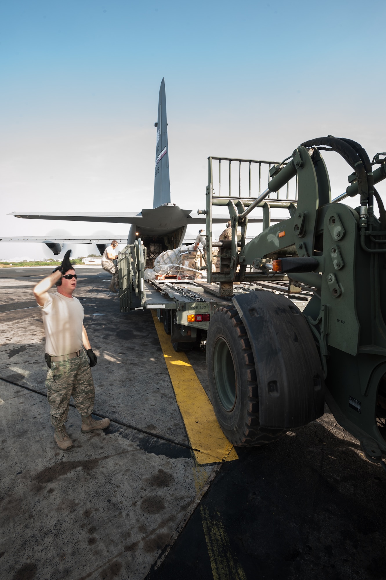 U.S. Air Force Tech. Sgt. Ryan McNary, an aerial porter from the Kentucky Air National Guard’s 123rd Contingency Response Group, directs humanitarian cargo onto a U.S. Air Force C-130J aircraft during an engines-running on-load at Léopold Sédar Senghor International Airport in Dakar, Senegal, Nov. 10, 2014. The aircraft and crew are deployed to Senegal from Dyess Air Force Base, Texas, as part of the 787th Air Expeditionary Squadron and will fly the cargo into Monrovia, Liberia, in support of Operation United Assistance, the U.S. Agency for International Development-led, whole-of-government effort to contain the Ebola virus outbreak in West Africa. (U.S. Air National Guard photo by Maj. Dale Greer)