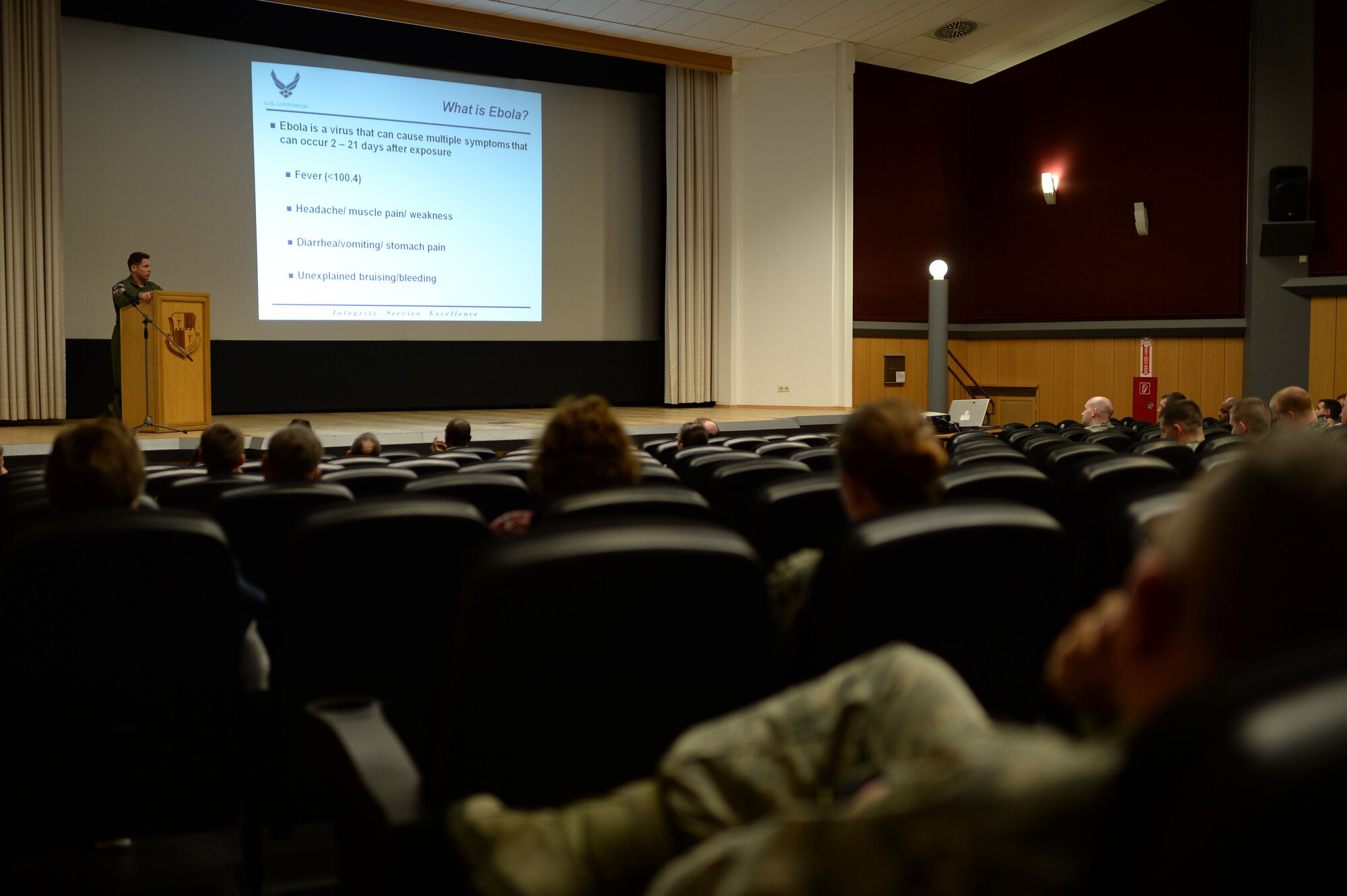 U.S. Air Force Lt. Col. Dan Murray, 52nd Aerospace Medicine Squadron commander and 52nd Fighter Wing public health emergency officer, speaks at a wing information forum Nov. 13, 2014, at the base theater regarding the Ebola virus disease, or EVD, and preventative actions the Airmen of Spangdahlem Air Base, Germany, are taking. Murray explained the symptoms of EVD and how someone can avoid contracting the virus. (U.S. Air Force photo by Staff Sgt. Daryl Knee/Released)