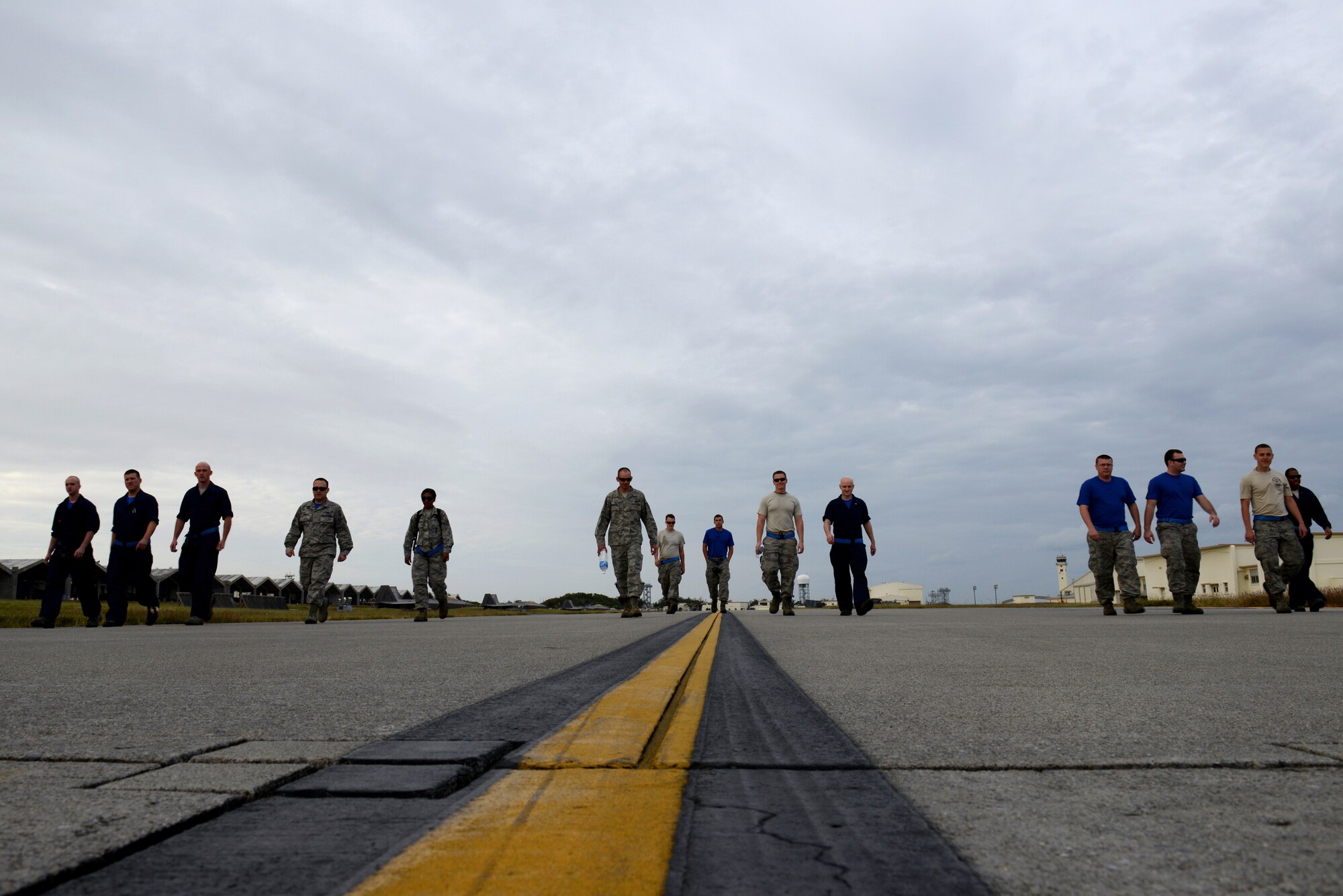 U.S. Air Force Airmen from the 525th Aircraft Maintenance Unit stationed at Joint Base Elmendorf-Richardson, Alaska, check the flight line for foreign object debris during Keen Sword 2015 on Kadena Air Base, Japan, Nov. 14, 2014. Keen Sword is a regularly scheduled exercise which strengthens Japan-U.S. military interoperability and meets mutual defense objectives. Japan-U.S. military operations and exercises increase readiness to respond to varied crisis situations in the region. (U.S. Air Force photo by Senior Airman Maeson L. Elleman/Released)