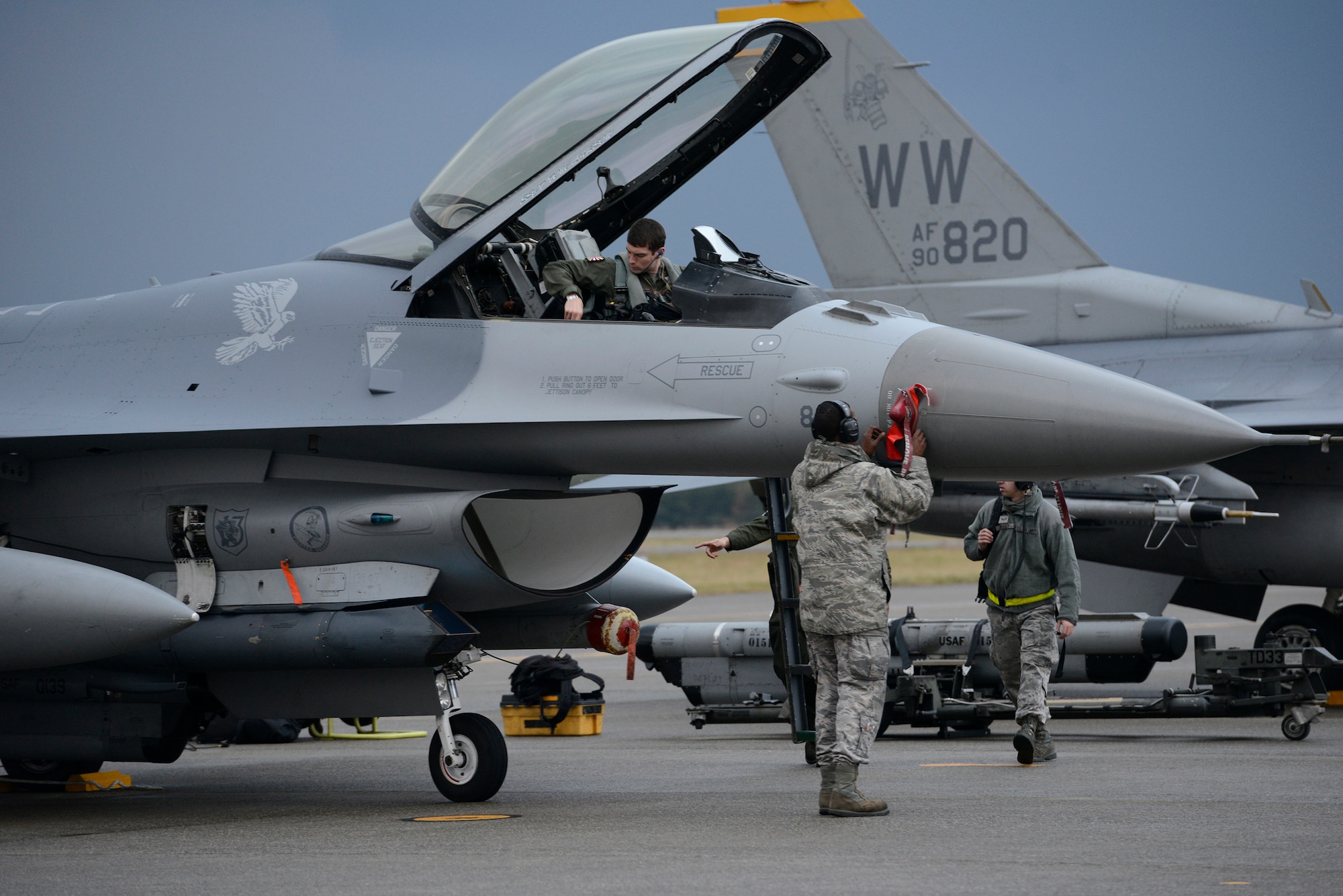Maintainers from Misawa Air Base, Japan, safe an F-16 Fighting Falcon upon its return to Komatsu Air Base, Japan, Nov. 12, 2014, while a pilot prepares to disembark. The F-16 and pilot are assigned to the 14th Fighter Squadron, which is currently at Komatsu in support of Aviation Training Relocation program operations. More than 120 Airmen from Misawa are on hand at Komatsu to practice and evaluate the coordination procedures and interoperability elements with the Japan Air Self Defense Force. Although the 14 FS is flying in an alternate training location, their suppression of enemy air defenses and defensive/offensive counterair mission remains the same. (U.S. Air Force photo by Staff Sgt. Alyssa C. Wallace/Released)