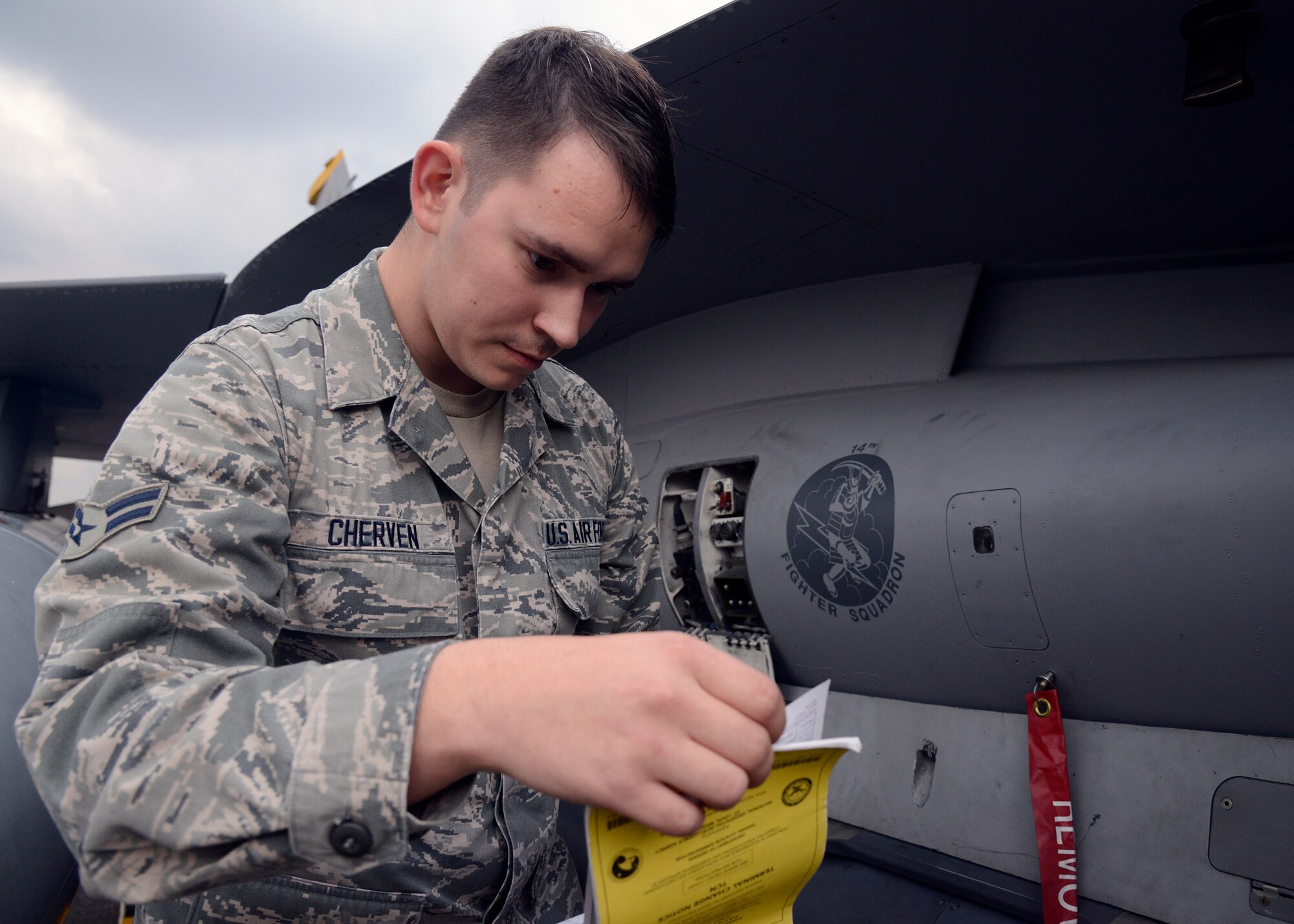 U.S. Air Force Airman 1st Class Christian Cherven, 14th Aircraft Maintenance Squadron avionics technician, reviews an F-16 Fighting Falcon flight form book while performing maintenance on the flightline at Komatsu Air Base, Japan, Nov. 12, 2014. Cherven and more than 80 maintainers from Misawa Air Base, Japan, are currently at Komatsu supporting the 14th Fighter Squadron as part of the Aviation Training Relocation Program. The ATR program allows U.S. and Japanese forces to further enhance their interoperability and joint partnership by conducting training away from the U.S. forces' home station, while also providing a noise respite for those living near the U.S. Air Force installations of the units participating in ATRs throughout Japan. The maintainers are on hand to fix mechanical issues that may arise with the jet, ensuring the aircraft is capable of performing suppression of enemy air defenses and defensive/offensive counterair missions. (U.S. Air Force photo by Staff Sgt. Alyssa C. Wallace/Released)