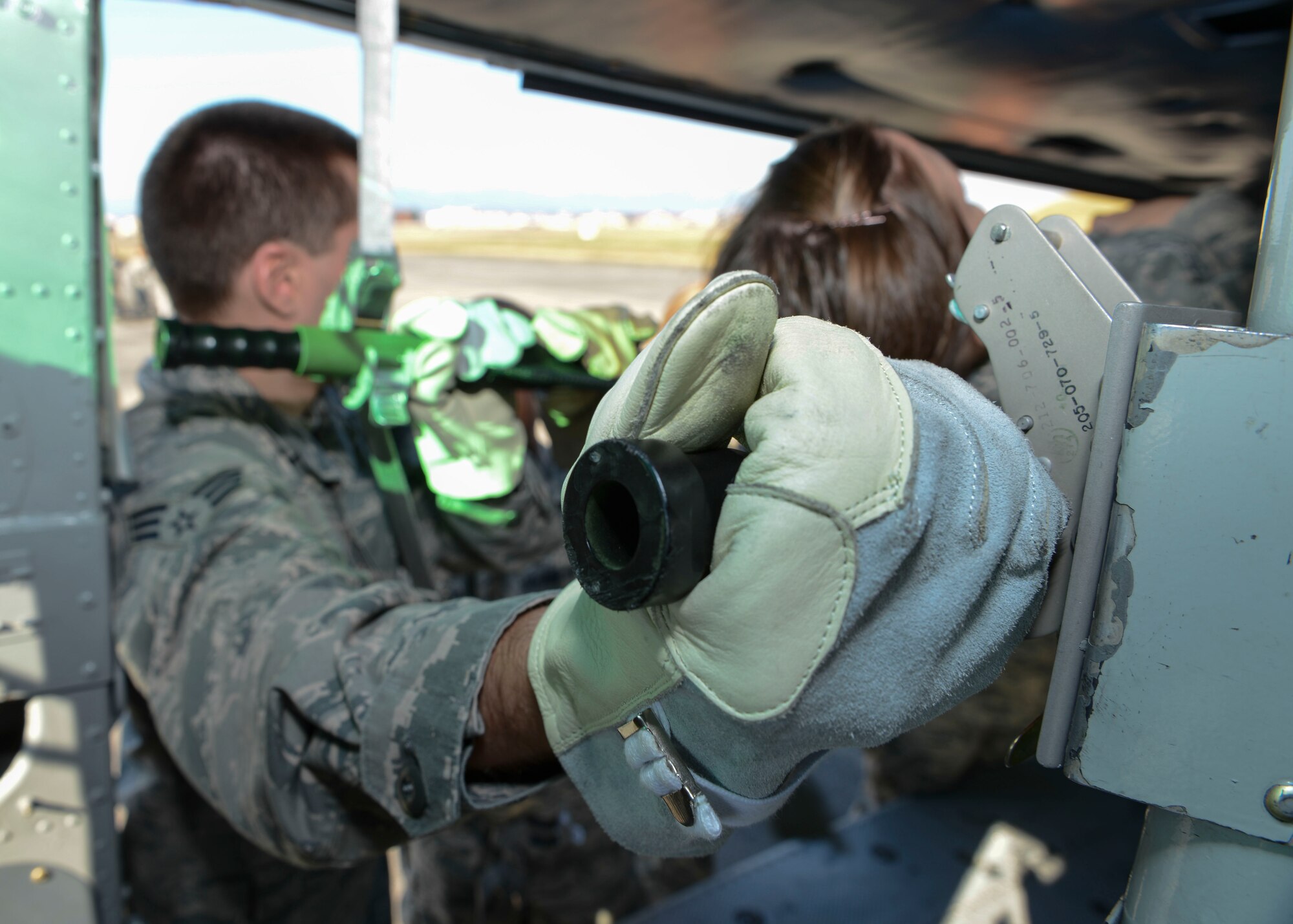Senior Airman Jacob Gillespie, 374th Medical Group public health technician, unloads a simulated patient from a UH-1N Huey during Exercise Keen Sword 2015 at Yokota Air Base, Japan, Nov. 13, 2014. Several members of 374 MDG had the opportunity to get hands-on training for aeromedical evacuation. (U.S. Air Force photo by Airman 1st Class Soo C. Kim/Released)