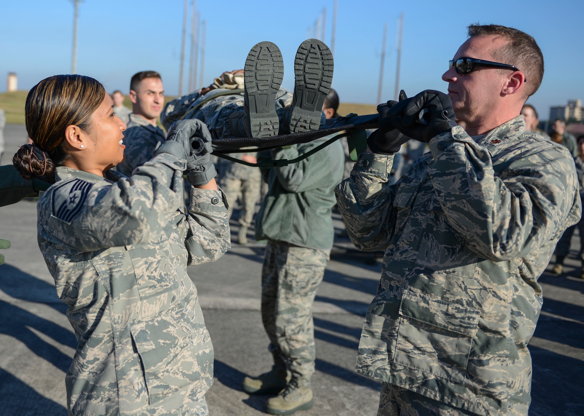 Members of 374th Medical Group lift a simulated patient above their shoulders during Exercise Keen Sword 2015 at Yokota Air Base, Japan, Nov. 13, 2014. Keen Sword is a routine exercise between the U.S. military and Japan, aimed to increase readiness to respond to varied crisis situations in the Pacific theater. (U.S. Air Force photo by Airman 1st Class Soo C. Kim/Released)