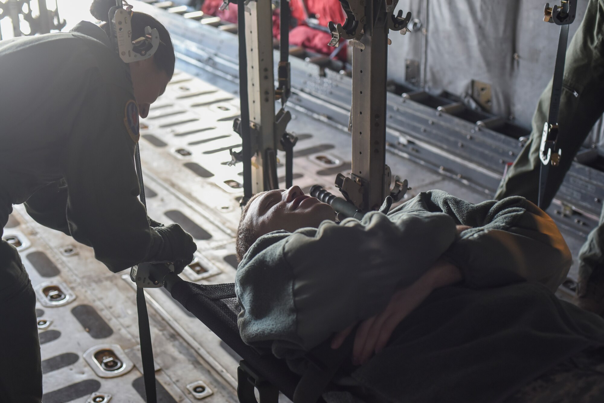 Airman 1st Class Troy Rathke, 374th Aerospace Medicine Squadron, simulates an injured patient as he gets loaded into the back of a C-130 during aeromedical evacuation training for Exercise Keen Sword 2015 at Yokota Air Base, Japan, Nov. 13, 2014. Members of the 374th Medical Group practiced loading and unloading litters from a C-130 Hercules, C-12 Huron and a UH-1N Huey helicopter. (U.S. Air Force photo by Senior Airman Michael Washburn/Released)