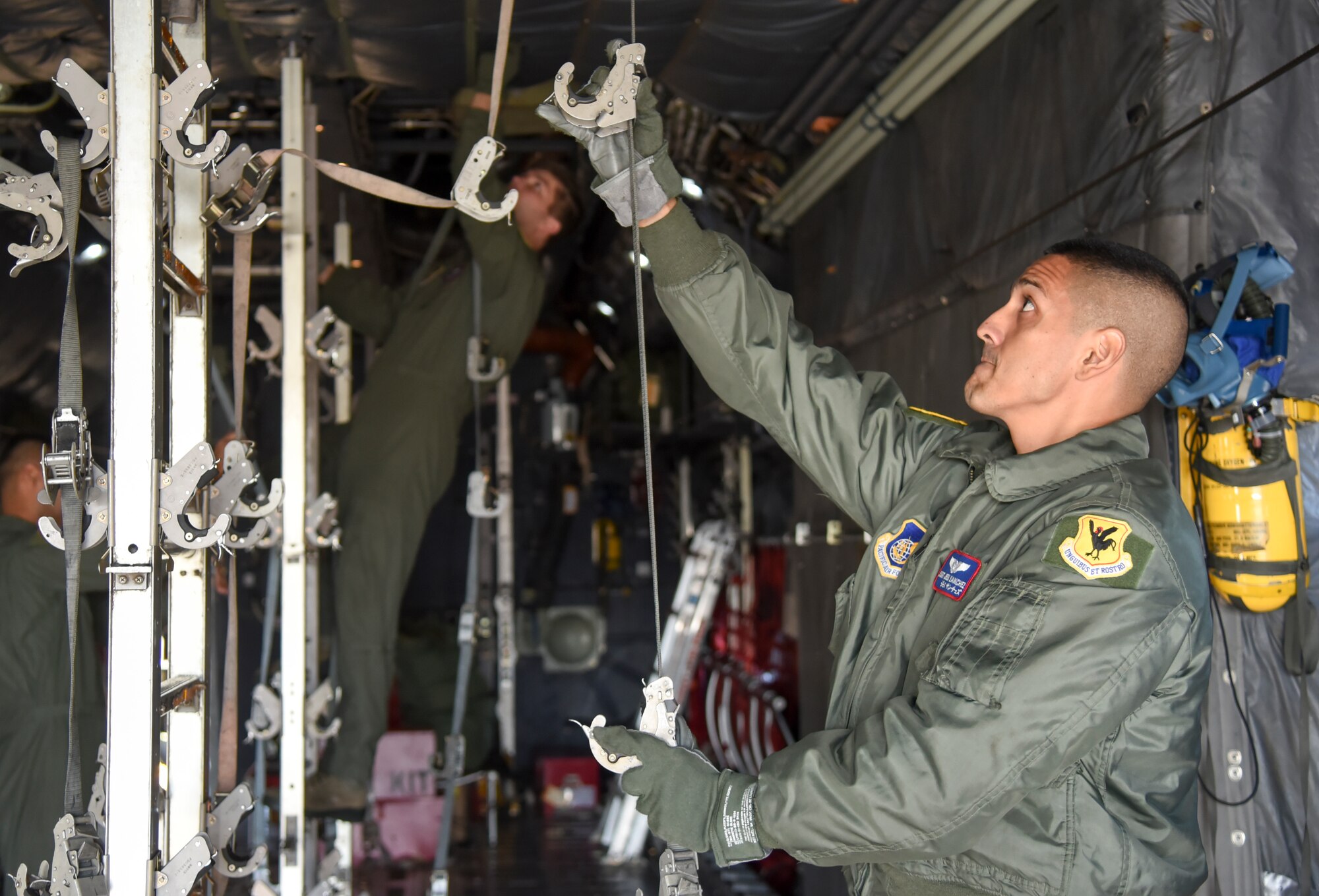 Staff Sgt. Jesus Sanchez, 18th Aeromedical Evacuation Squadron technician, sets up a litter in the back of a C-130 during aeromedical evacuation training for Exercise Keen Sword 2015 at Yokota Air Base, Japan, Nov. 13, 2014. A C-130 can hold a maximum of 52 litters, while the J-model can hold 92. (U.S. Air Force photo by Senior Airman Michael Washburn/Released)