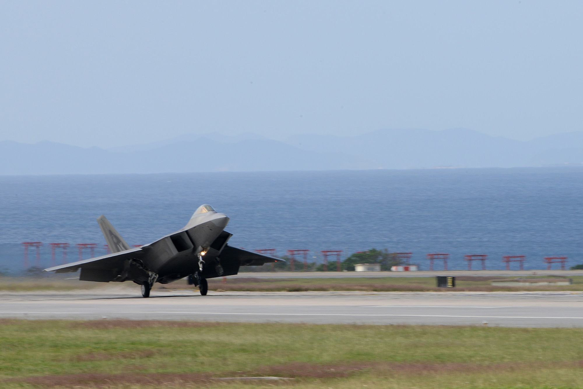 A U.S. Air Force F-22 Raptor from the 525th Fighter Squadron stationed at Joint Base Elmendorf-Richardson, Alaska, lands on the Kadena Air Base, Japan, runway during Keen Sword 2015 Nov. 14, 2014. The F-22 implements a combination of stealth, supercruise, high maneuverability and integrated avionics in order to project air dominance rapidly and at great distances in order to maintain to defeat threats and protect the U.S. and host nation allies in the region. (U.S. Air Force photo by Senior Airman Maeson L. Elleman/Released)