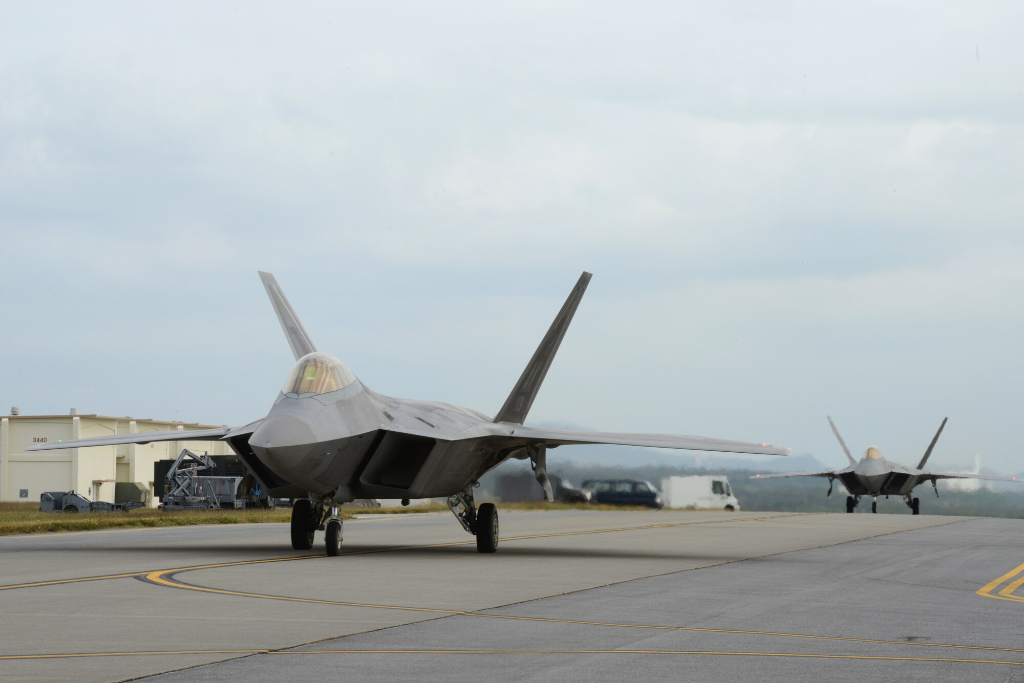 Two U.S. Air Force F-22 Raptors from the 525th Fighter Squadron stationed at Joint Base Elmendorf-Richardson, Alaska, taxi on the Kadena Air Base, Japan, flight line before takeoff Nov. 14, 2014. The Raptors, which are temporarily operating out of Kadena, are participating in Keen Sword 2015, a joint bilateral field training exercise involving U.S. military and Japan Self-Defense Force personnel. Keen Sword is designed to increase combat readiness and interoperability between the JSDF and U.S. forces and will be conducted at multiple venues in the Japan area of responsibility. (U.S. Air Force photo by Senior Airman Maeson L. Elleman/Released)